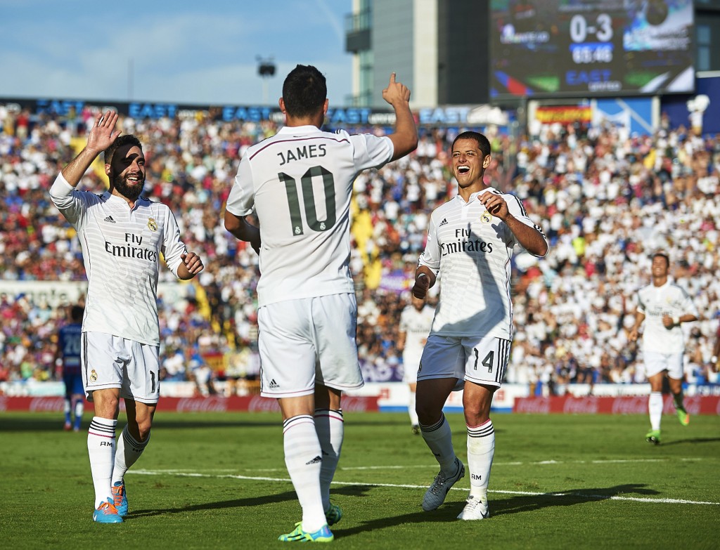 VALENCIA, SPAIN - OCTOBER 18: James Rodriguez of Real Madrid celebrates after scoring with his teammates Daniel Carvajal (L) and Javier 'Chicharito' Hernandez (R) during the La Liga match between Levante UD and Real Madrid at Ciutat de Valencia on October 18, 2014 in Valencia, Spain. (Photo by Manuel Queimadelos Alonso/Getty Images)