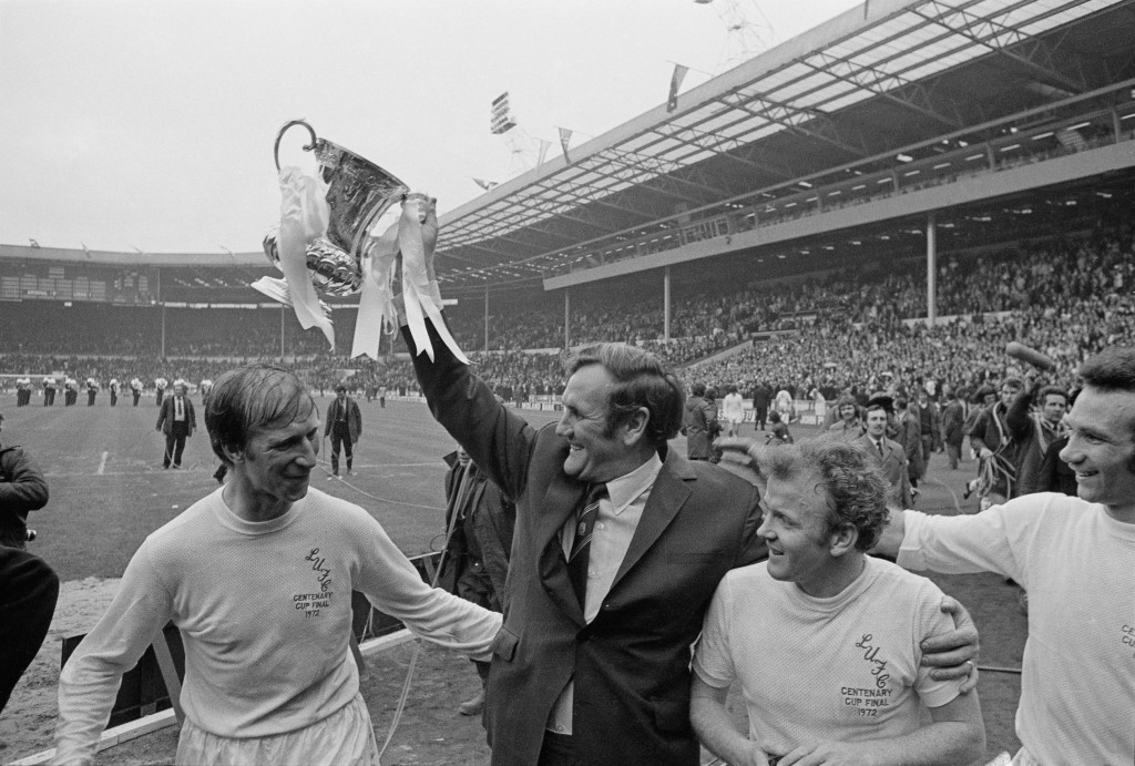 Leeds United F.C. manager Don Revie (1927 - 1989) lifts the 'FA Cup' trophy after his players beat Arsenal F.C. to win the FA Cup Final, Wembley Stadium, London, 6th May 1972. Also shown are Jack Charlton (left), Billy Bremner (1942 - 1997), and Paul Reaney (far right). (Photo by Express/Hulton Archive/Getty Images)