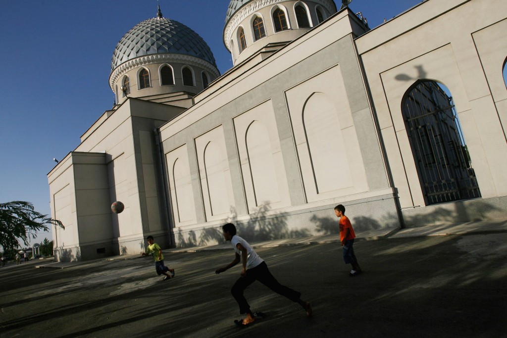 TASHKENT, UZBEKISTAN - AUGUST 16: (ISRAEL OUT) Uzbek boys play football outside the Juma Mosque on August 16, 2006 in Tashkent in the central Asian country of Uzbekistan. Fifteen years after the breakup of the former USSR, the millions of Muslims living between the Caspian Sea and China, who for decades found themselves repressed under Communism, are experiencing a religious revival as neighboring regional powers Iran and Saudi Arabia strive to exert their influence on the vast region. Following the August 1991 abortive coup attempt in Moscow and the subsequent dissolution of the Soviet Union, Uzbekistan declared independence on August 31, 1991. (Photo by Uriel Sinai/Getty Images)