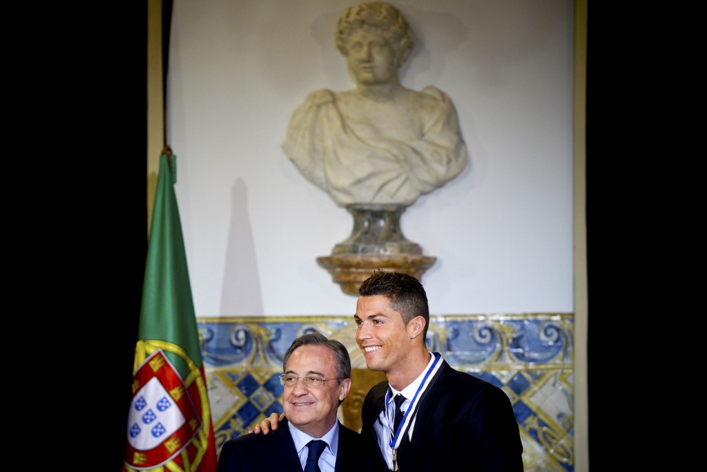 Portuguese forward Cristiano Ronaldo (R) poses with Real Madrid President Florentino Perez after being awarded by the Portuguese President Anibal Cavaco Silva (unseen) with the grade of Grand Officer of the Order of Prince Henry the Navigator during a ceremony held at Belem Palace on January 20, 2014. The portuguese president decided to distinguish Cristiano Ronaldo for being a worldwide symbol of Portugal, thus contributing towards the Country's international image, and an example of perseverance for the new generations. AFP PHOTO/ PATRICIA DE MELO MOREIRA (Photo credit should read PATRICIA DE MELO MOREIRA/AFP/Getty Images)