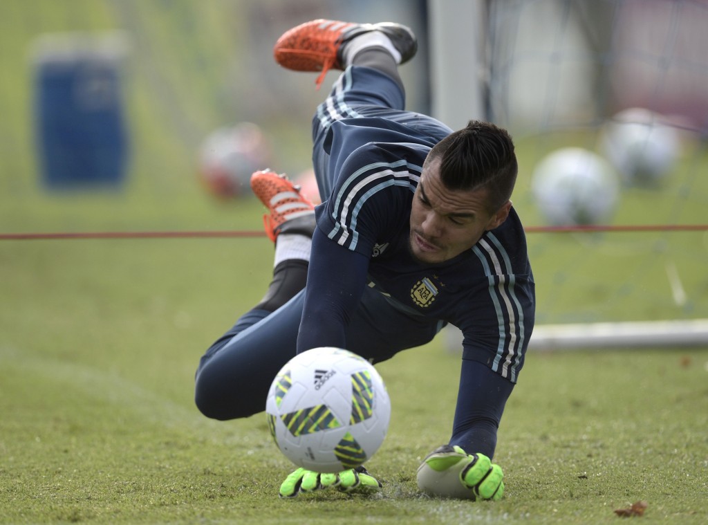 Argentina's goalkeeper Sergio Romero stops the ball during a training session in Ezeiza, Buenos Aires on March 21, 2016 ahead of a 2018 FIFA World Cup Russia South American qualifier football match against Chile to be held in Santiago on March 24. AFP PHOTO / JUAN MABROMATA / AFP / JUAN MABROMATA (Photo credit should read JUAN MABROMATA/AFP/Getty Images)