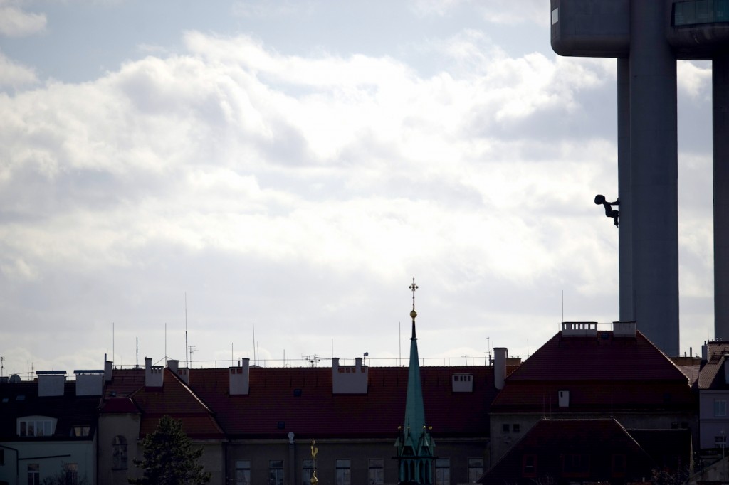 Photo taken on February 27, 2010 from the Vitkov National Memorial in Prague shows the roofs of the Zizkov district and "climbing baby" by artist David Cerny adorning the Zizkov Television Tower. AFP PHOTO /MICHAL CIZEK (Photo credit should read MICHAL CIZEK/AFP/Getty Images)