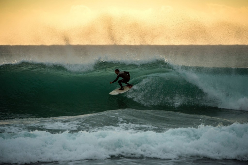 A surfer rides a wave at Varazze on January 8, 2016 during swells and rising winds in the Gulf of Liguria, northwestern Italy. / AFP / OLIVIER MORIN (Photo credit should read OLIVIER MORIN/AFP/Getty Images)