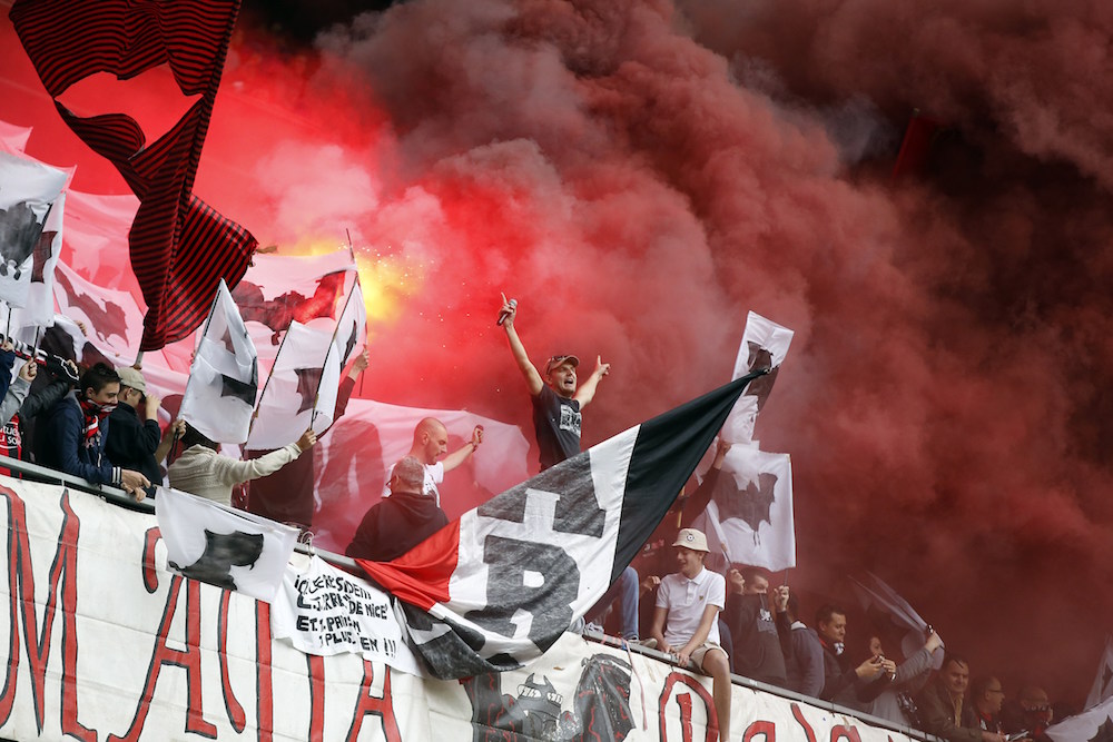 Nice's supporters cheer their team during the French L1 football match betweem Nice and Paris on April 18, 2015 at the "Allianz Riviera" stadium in Nice, southeastern France. AFP PHOTO / VALERY HACHE (Photo credit should read VALERY HACHE/AFP/Getty Images)