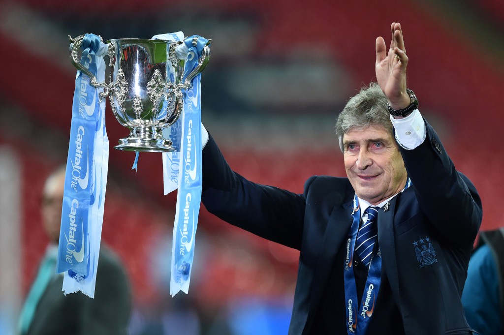 TOPSHOT - Manchester City's Chilean manager Manuel Pellegrini holds up the League cup after the presentation after City won the English League Cup final football match between Liverpool and Manchester City at Wembley Stadium in London on February 28, 2016. / AFP / BEN STANSALL / RESTRICTED TO EDITORIAL USE. No use with unauthorized audio, video, data, fixture lists, club/league logos or 'live' services. Online in-match use limited to 75 images, no video emulation. No use in betting, games or single club/league/player publications. / (Photo credit should read BEN STANSALL/AFP/Getty Images)