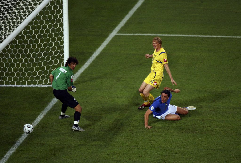 HAMBURG, GERMANY - JUNE 30: Luca Toni (R) of Italy scores his team's third goal past Goalkeeper Oleksandr Shovkovskyi (L) of the Ukraine during the FIFA World Cup Germany 2006 Quarter-final match between Italy and Ukraine at the Stadium Hamburg on June 30, 2006 in Hamburg, Germany. (Photo by Michael Steele/Getty Images)