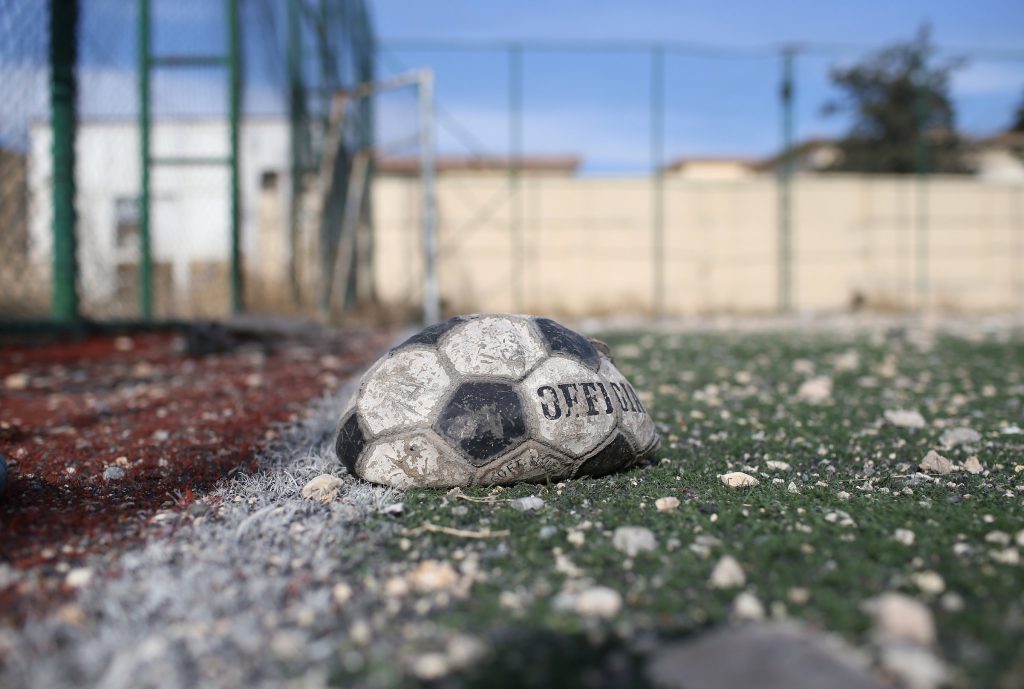 SINJAR, IRAQ - NOVEMBER 15: A deflated soccer ball lies next to a building hit by an airstrike on November 15, 2015 in Sinjar, Iraq. Kurdish forces, with the aid of massive U.S.-led coalition airstrikes, liberated Sinjar from ISIL extremists, known in Arabic as Daesh, in recent days. Local Yazidi fighters who fought with Kurdish forces have been taking any salvagable items out of the rubble, the town being uninhabitable and perilously close to the frontline. (Photo by John Moore/Getty Images)