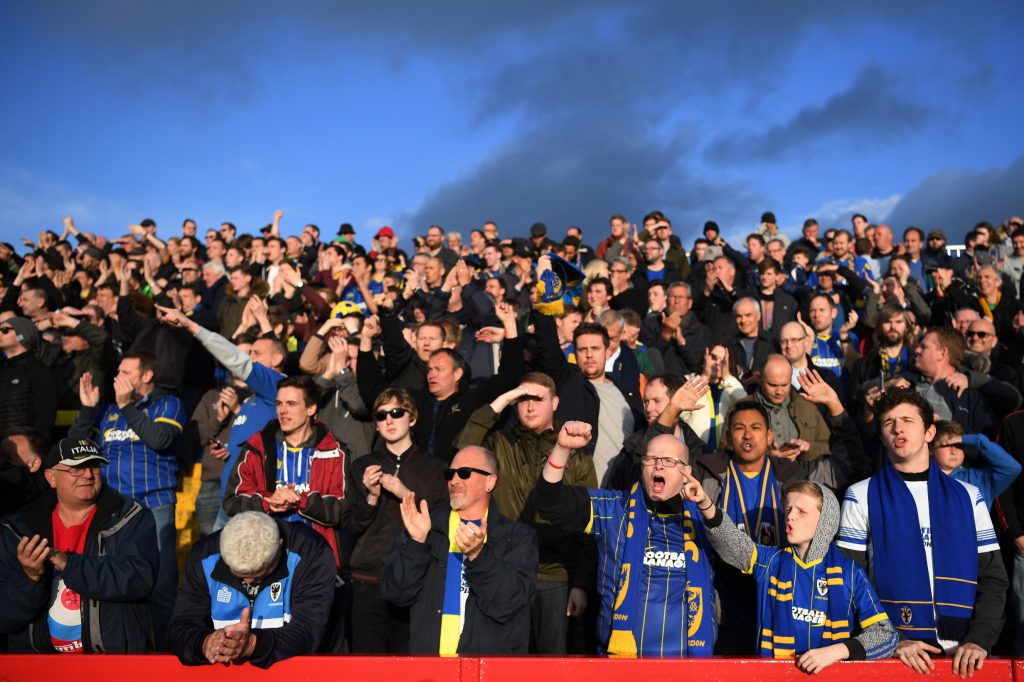 ACCRINGTON, ENGLAND - MAY 18: AFC Wimbledon fans cheer on their team during the Sky Bet League Two play off, Second Leg match between Accrington Stanley and AFC Wimbledon at The Crown Ground on May 18, 2016 in Accrington, England. (Photo by Laurence Griffiths/Getty Images)