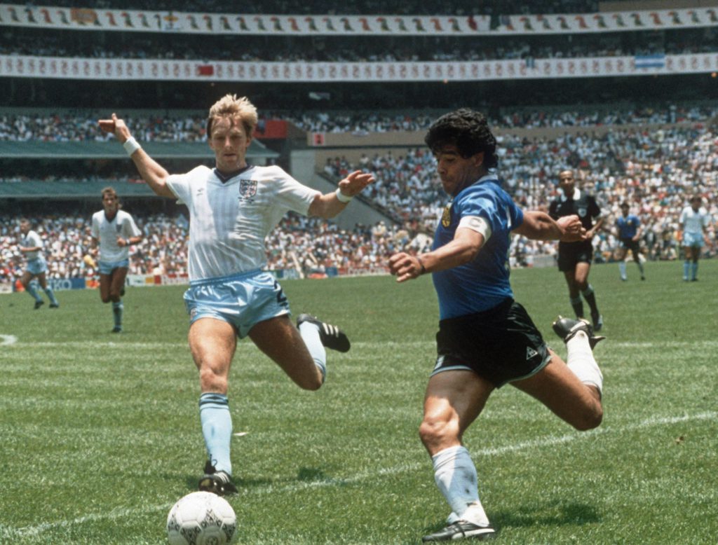 Argentinian forward Diego Maradona (R) gets ready to cross the ball under pressure from English defender Gary Stevens during the World Cup quarterfinal soccer match between Argentina and England 22 June 1986 in Mexico City. Argentina beat England 2-1 on goals by Maradona. AFP PHOTO (Photo credit should read STAFF/AFP/Getty Images)