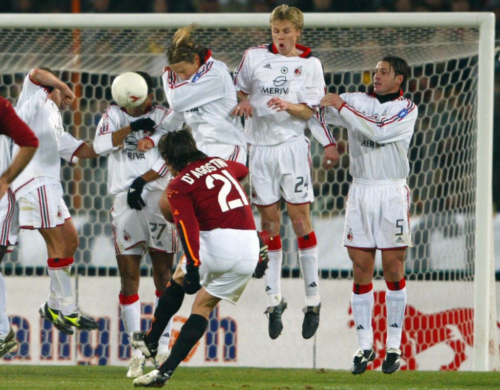 ROME, ITALY: Roma's Gaetano D'agostino (C) shoots a free kick against AC Milan's , during their italian cup quarter-final soccer match, 22 January 2004 at the Olympic stadium in Rome. AFP PHOTO/ Patrick HERTZOG (Photo credit should read PATRICK HERTZOG/AFP/Getty Images)