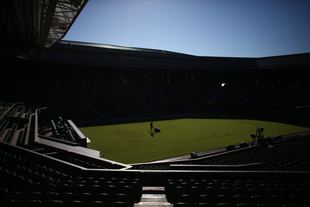 LONDON, ENGLAND - JUNE 30: A member of the ground staff mows the grass on centre court on day two of Wimbledon tennis tournament on June 30, 2015 in London, England. The 129th tournament to be hosted at Wimbledon is due to run for two weeks from Monday 29th June. (Photo by Carl Court/Getty Images)