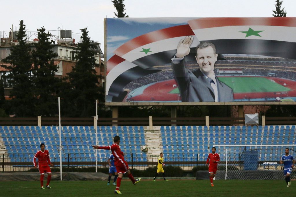 Un poster di Assad a Damasco, marzo 2016 (Louai Beshara/Afp/Getty Images)