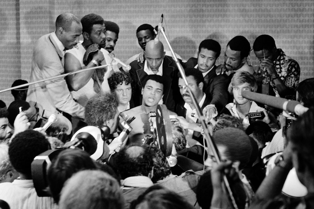 TO GO WITH AFP STORIES In this photo taken on October 30, 1974 shows US boxing heavyweight champion Muhammad Ali (C) (born Cassius Clay) during a press conference after the heavyweight world championship in Kinshasa. On October 30, 1974 Muhammad Ali knocked out George Foreman in a clash of titans known as the "Rumble in the Jungle", watched by 60 000 people in the stadium in Kinshasa and millions elsewhere AFP PHOTO (Photo credit should read STR/AFP/Getty Images)