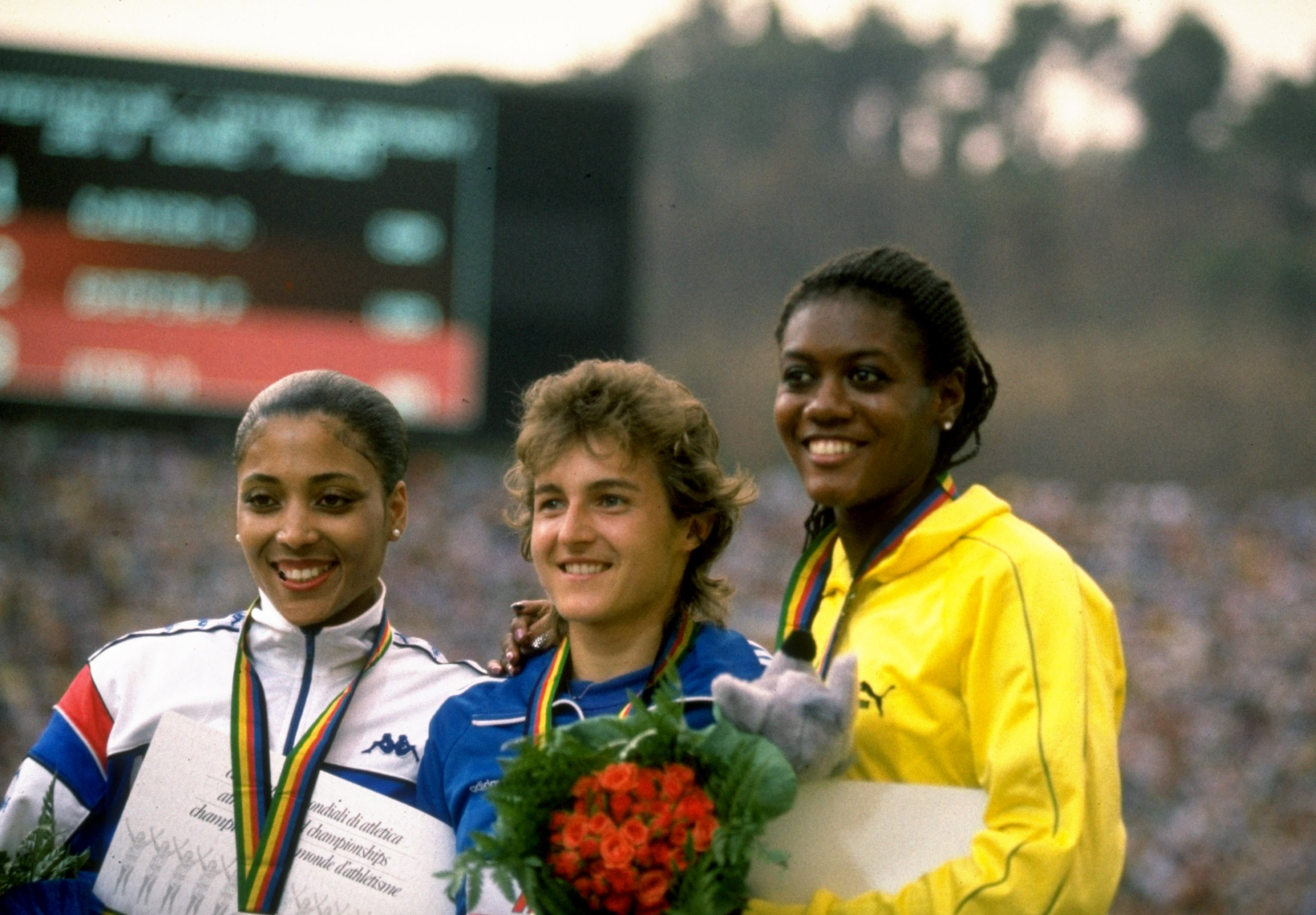 3 Sep 1987: Silke Gladisch (centre) of East Germany on the podium after the 200m with Merlene Ottey of Jamaica (right) and Florence Griffith Joyner of the USA (left) during the World Championships at the Olympic Stadium in Rome. Gladisch won Gold. Mandatory Credit: Tony Duffy/Allsport