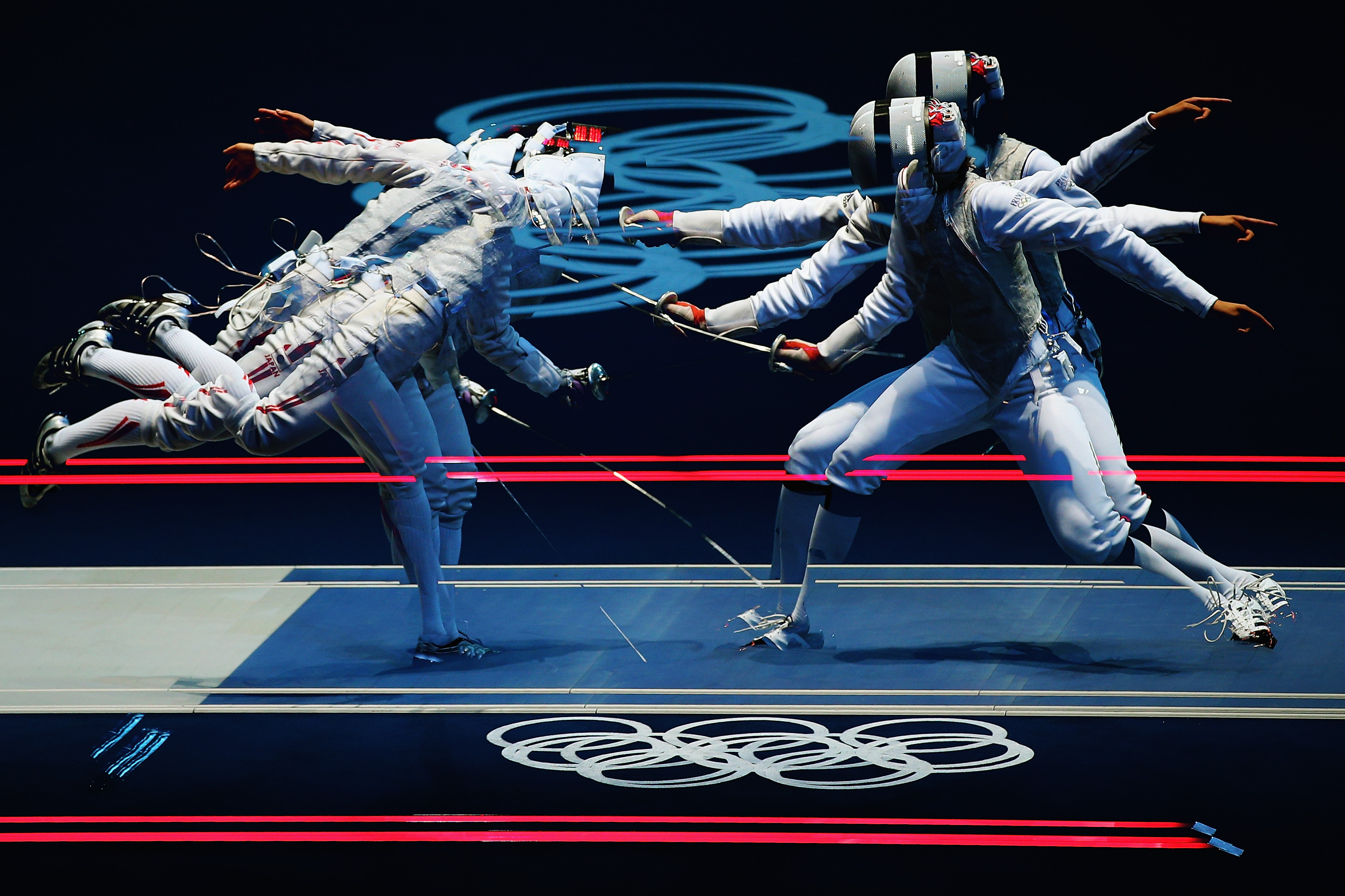 LONDON, ENGLAND - JULY 28: (EDITORS NOTE: Multiple exposures were combined in camera to produce this image.) Carolin Golubytskyi of Germany competes against Elisa Di Francisca of Italy in their Women's Foil Individual Fencing round of 16 match on Day 1 of the London 2012 Olympic Games at ExCeL on July 28, 2012 in London, England. (Photo by Hannah Peters/Getty Images)