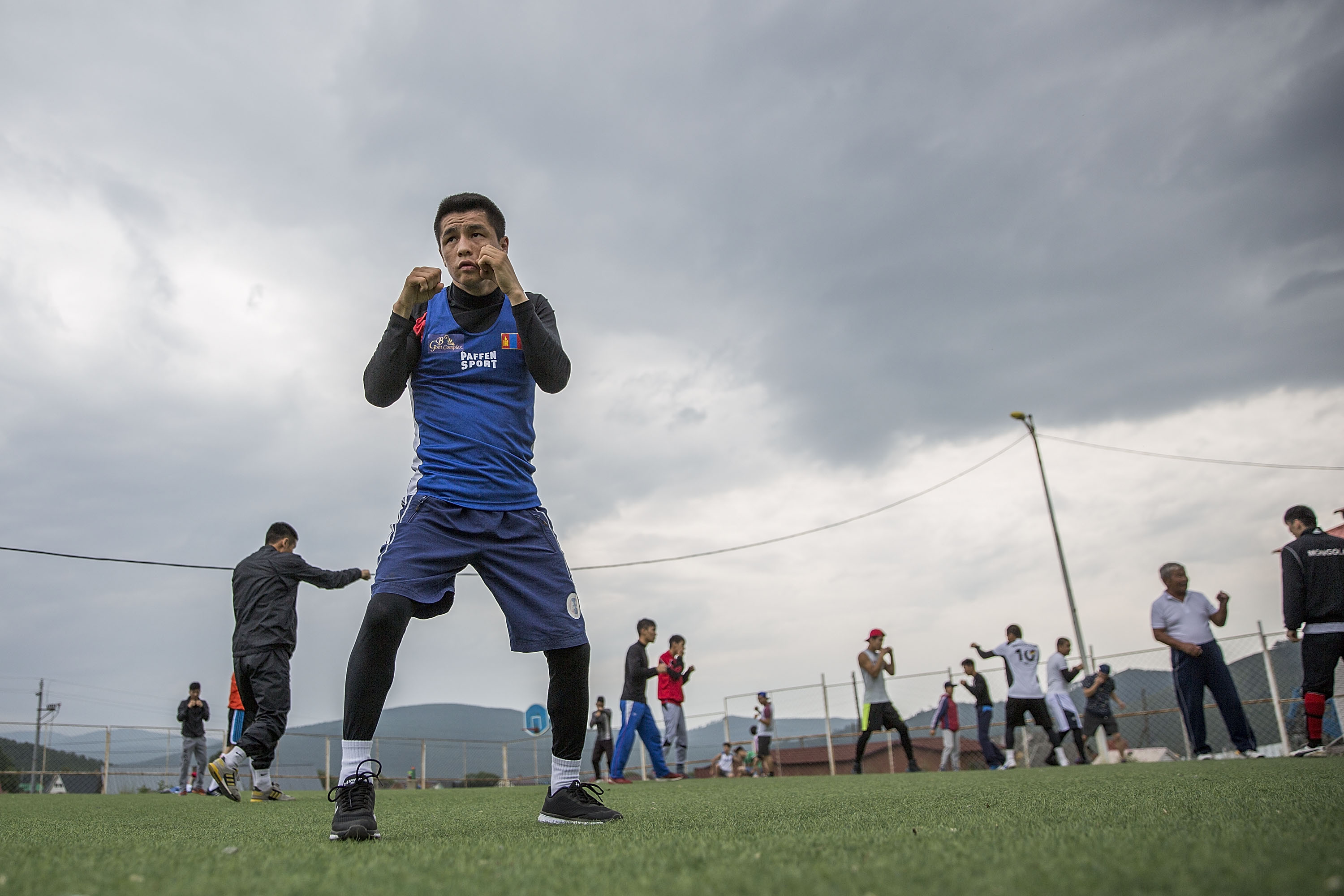 ULAANBAATAR, MONGOLIA - JULY 14: Gan-Erdene Gankhuyag, Olympic boxer at 49kg, trains on a soccer pitch during a Mongolian Olympic Games boxing team training session at Ikh Tamir Olympic Sports Complex on July 14, 2016 near Ulaanbaatar, Mongolia. The boxing team occasionally plays other sports in an effort to introduce variety and improve reaction time, speed, stamina, and strength. (Photo by Taylor Weidman/Getty Images)