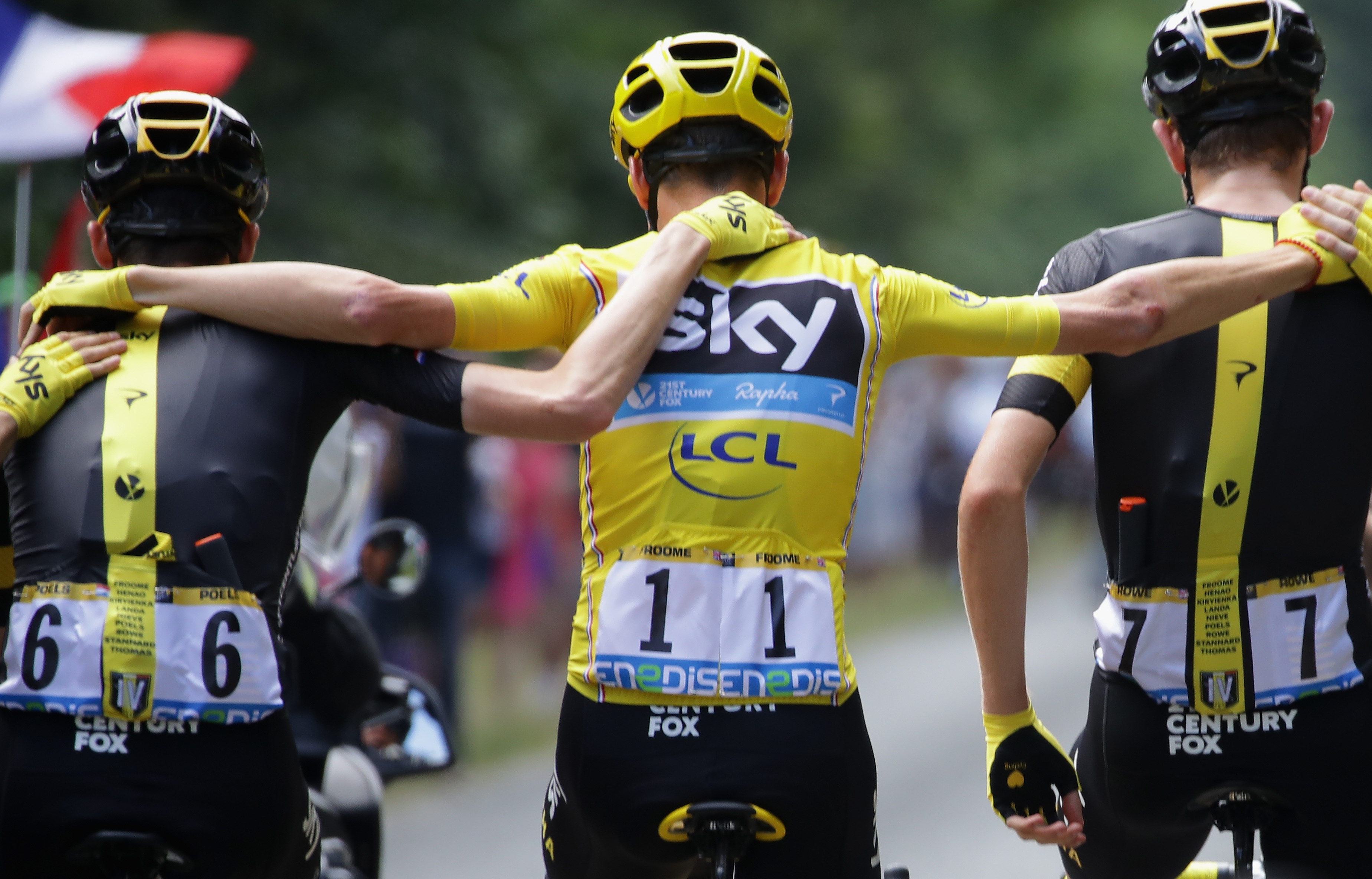 PARIS, FRANCE - JULY 24: Chris Froome of Great Britain and Team Sky (yellow jersey) links arms wit Wout Poels of the Netherlands and Team Sky and Luke Rowe of Great Britain and Team Sky during stage twenty one of the 2016 Le Tour de France, from Chantilly to Paris Champs-Elysees on July 24, 2016 in Paris, France. (Photo by Chris Graythen/Getty Images)