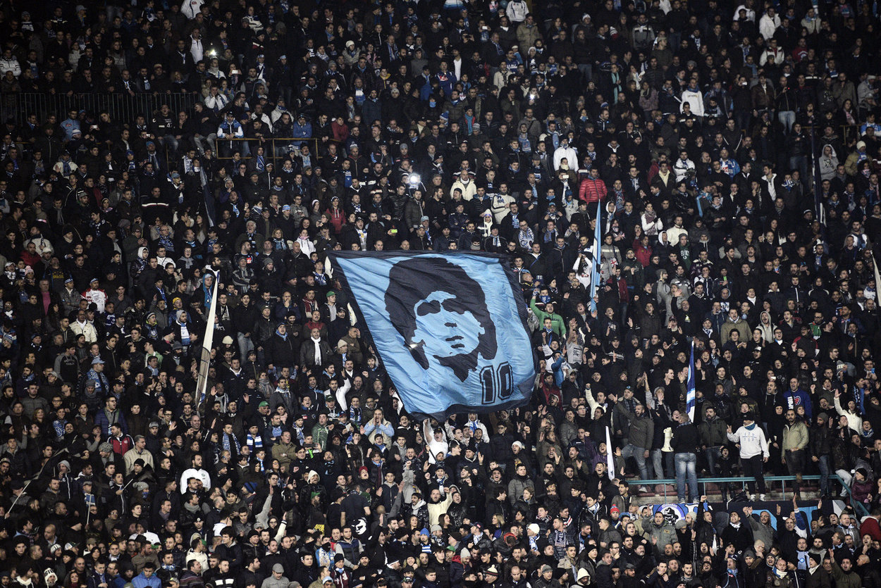 SSC Napoli's fans show a flag rapresenting Argentinian former SSC Napoli player Diego Armando Maradona during the Serie A football match SSC Napoli vs A.S. Roma at San Paolo Stadium in Naples on January 6, 2013. AFP PHOTO / ROBERTO SALOMONE (Photo credit should read ROBERTO SALOMONE/AFP/Getty Images)