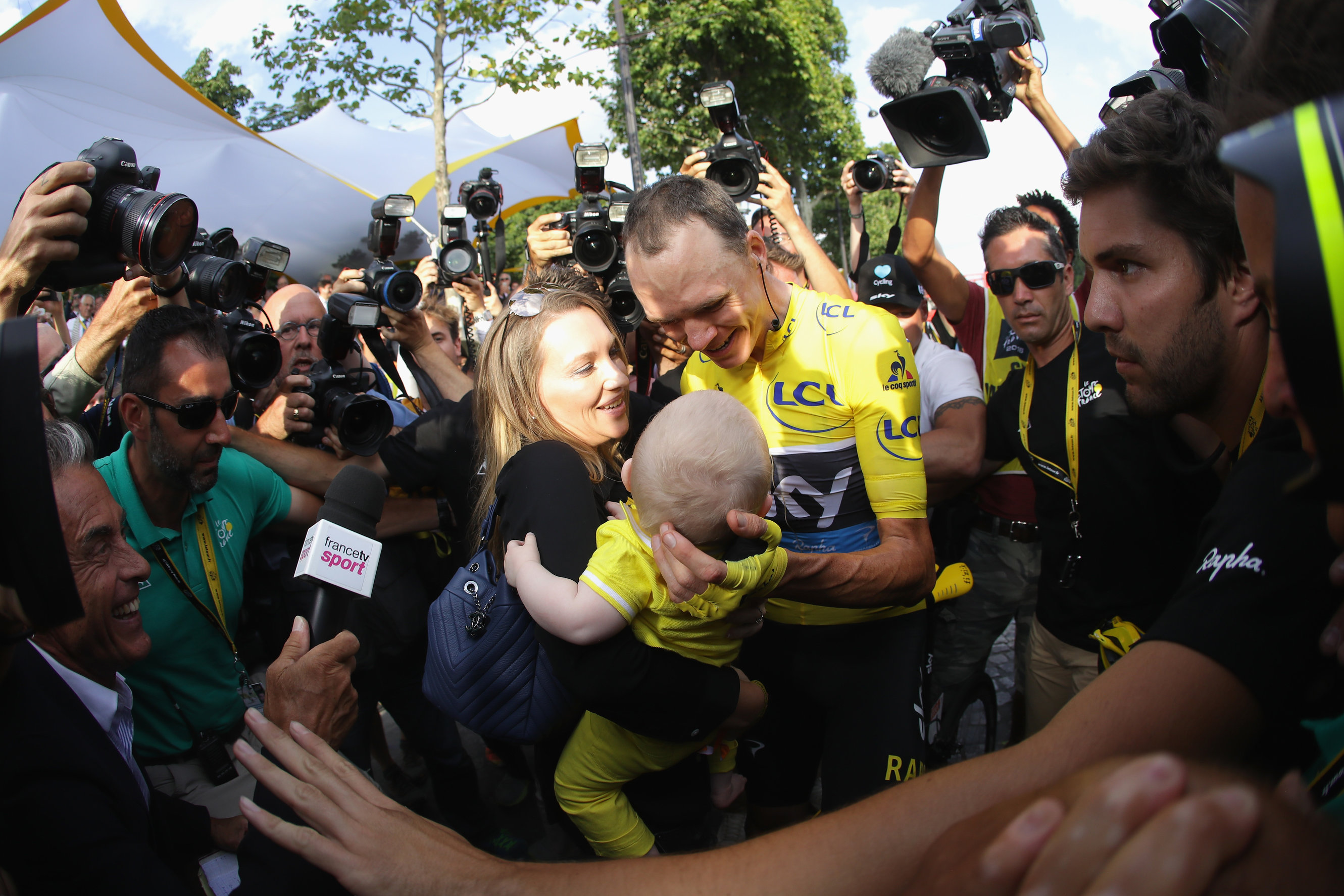 PARIS, FRANCE - JULY 24: Chris Froome of Great Britain and Team Sky celebrates victory with his family as he is surrounded by the media during stage twenty one of the 2016 Le Tour de France, from Chantilly to Paris Champs-Elysees on July 24, 2016 in Paris, France. (Photo by Chris Graythen/Getty Images)