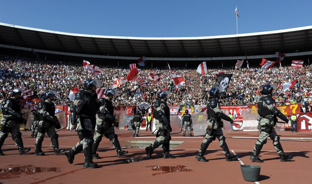 Serbian anti riot police officers enter Belgrade's "Marakana" stadium prior to the Serbian football derby match on October 23, 2010. Heavy police presence and strict fans' control prevented feared violence at the tense Serbian derby today won by Partizan against its main local rival Red Star Belgrade. Several thousands policemen were engaged since early morning hours, controlling groups of fans coming to the match in a clear bid to avoid any incidents following violent riots by Serbian hooligans on October 12 in aborted Serbia's Euro 2012 qualifier against Italy in Genoa. AFP PHOTO / Andrej ISAKOVIC (Photo credit should read ANDREJ ISAKOVIC/AFP/Getty Images)