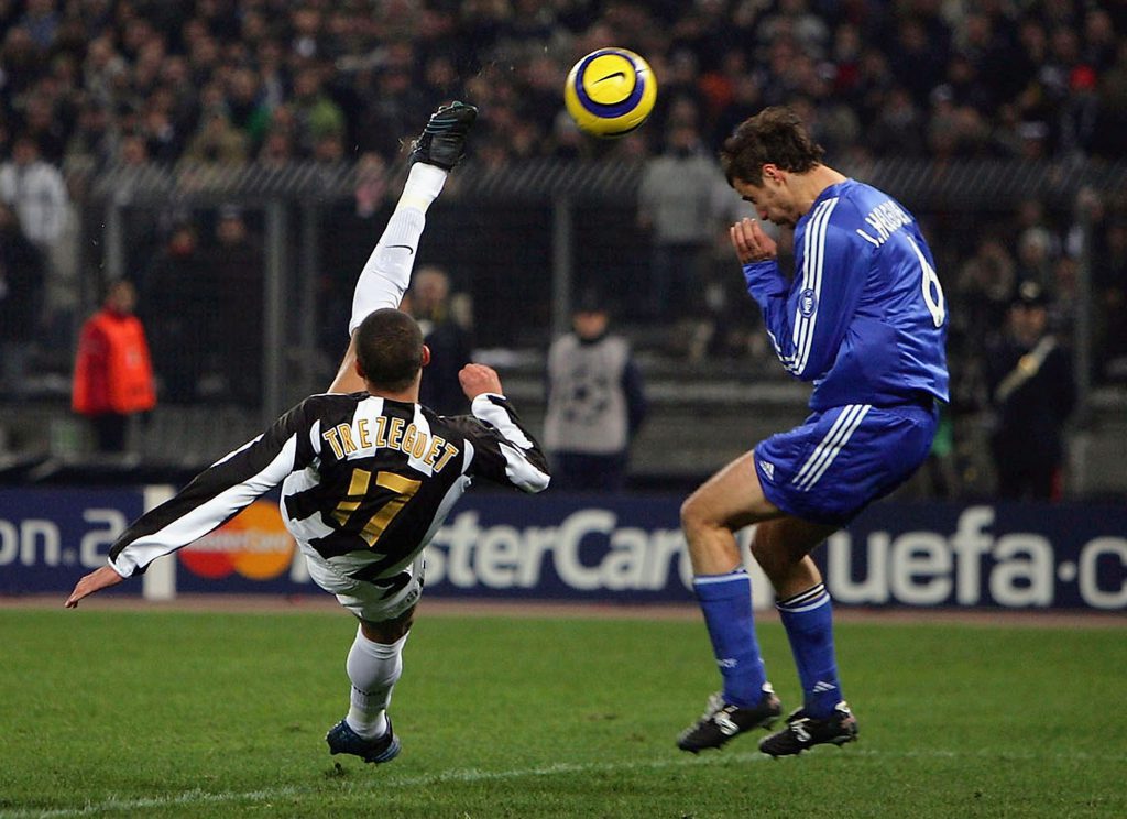 TURIN, ITALY - MARCH 9: David Trezeguet of Juventus scores with a spectacular overhead kick which Ivan Helguera of Real Madrid cannot block during the UEFA Champions League first knock-out round, second leg between Juventus and Real Madrid on March 9, 2005 at the San Siro Stadium in Milan, Italy. (Photo by Mike Hewitt/Getty Images)