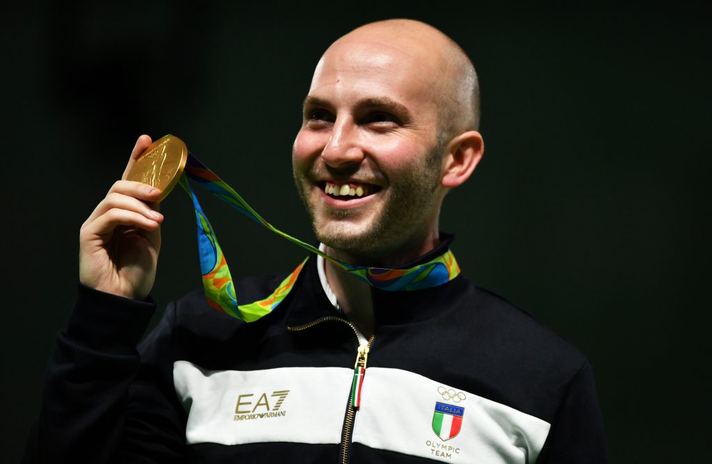 Gold medal Italy's Niccolo' Campriani celebrates on the podium during the medal ceremony for the 50m Rifle 3 positions men's Finals shooting event at the Rio 2016 Olympic Games at the Olympic Shooting Centre in Rio de Janeiro on August 14, 2016. / AFP / PASCAL GUYOT        (Photo credit should read PASCAL GUYOT/AFP/Getty Images)