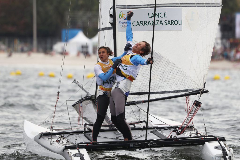 RIO DE JANEIRO, BRAZIL - AUGUST 16: Santiago Lange of Argentina and Cecilia Carranza Saroli of Argentina celebrate winning the gold medal in the Nacra 17 Mixed class on Day 11 of the Rio 2016 Olympic Games at the Marina da Gloria on August 16, 2016 in Rio de Janeiro, Brazil. (Photo by Clive Mason/Getty Images)