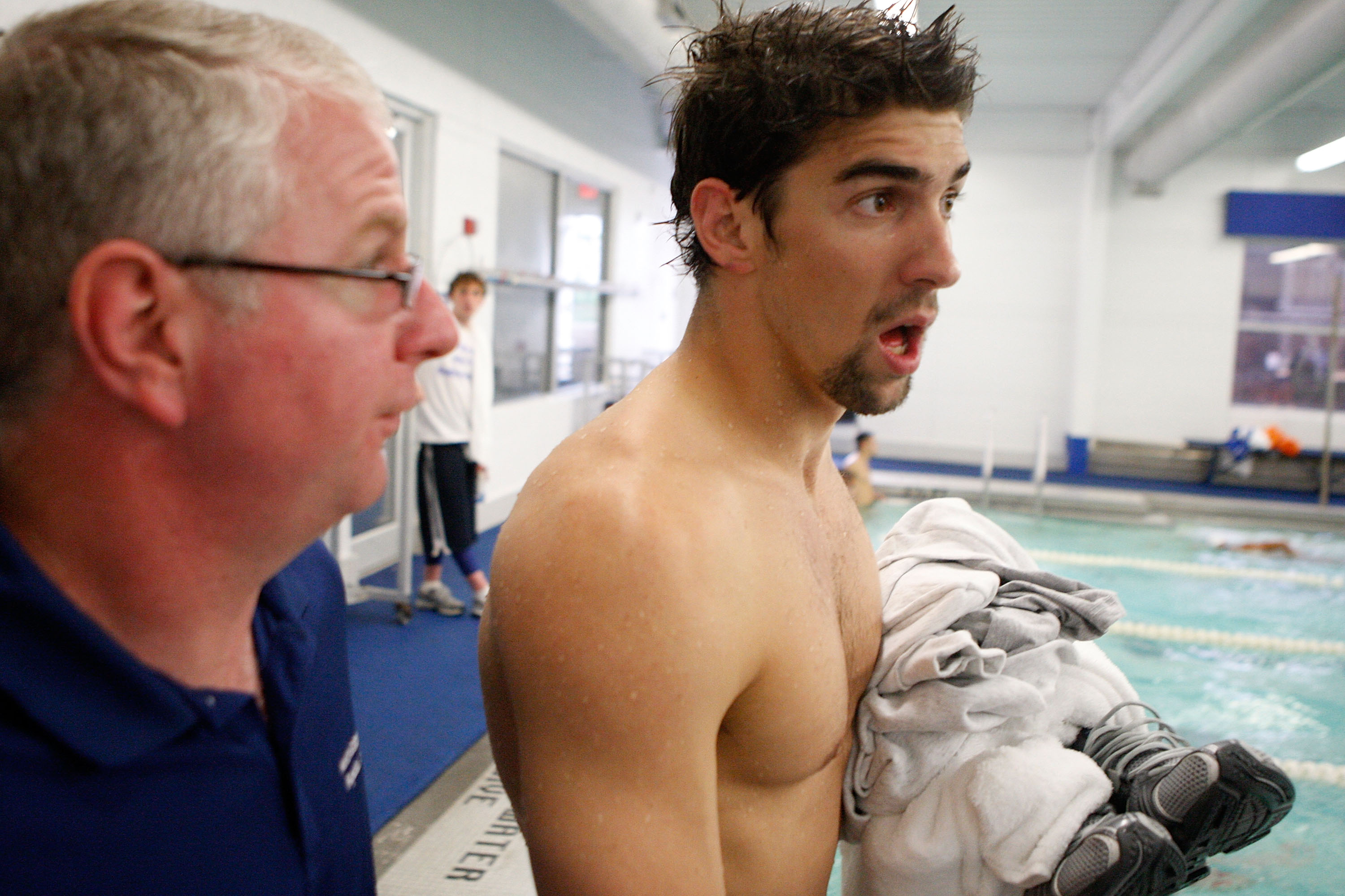 CHARLOTTE, NC - MAY 15: Michael Phelps talks to his coach, Bob Bowman, after winning the Men's 100m Butterfly and 200m Freestyle during the Charlotte Ultra Swim at the Charlotte Aquatic Center on May 15, 2009 in Charlotte, North Carolina. (Photo by Streeter Lecka/Getty Images)