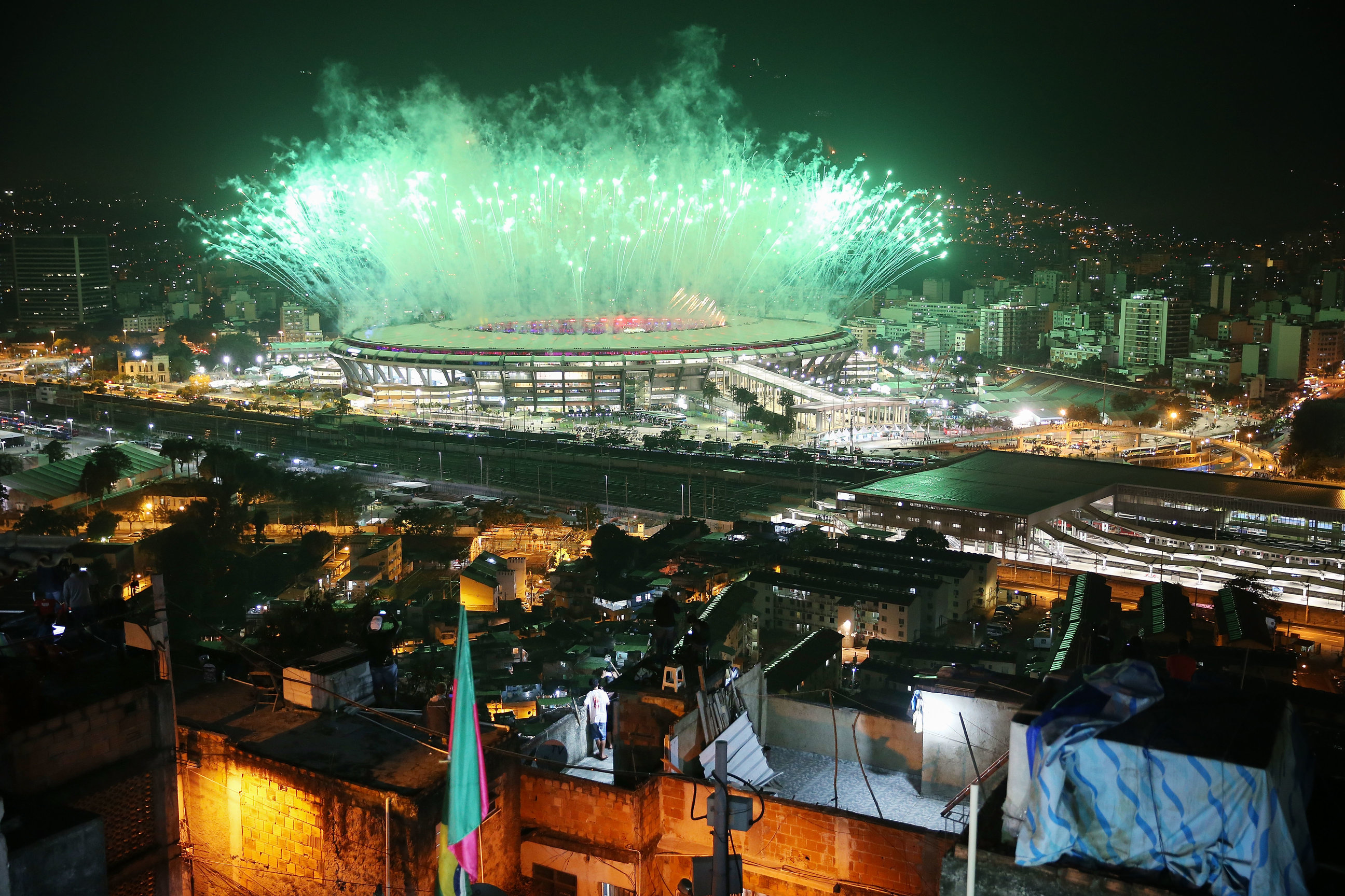 RIO DE JANEIRO, BRAZIL - AUGUST 05: Fireworks explode over Maracana stadium with the Mangueira 'favela' community in the foreground during opening ceremonies for the Rio 2016 Olympic Games on August 5, 2016 in Rio de Janeiro, Brazil. The Rio 2016 Olympic Games commenced tonight at the iconic stadium. (Photo by Mario Tama/Getty Images)