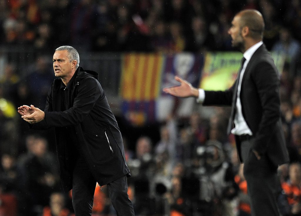 Real Madrid's Portuguese coach Jose Mourinho (L) and Barcelona's coach Josep Guardiola react during the Spanish League "El clasico" football match Barcelona vs Real Madrid at the Camp Nou stadium in Barcelona on April 21, 2012. AFP PHOTO / LLUIS GENE (Photo credit should read LLUIS GENE/AFP/Getty Images)