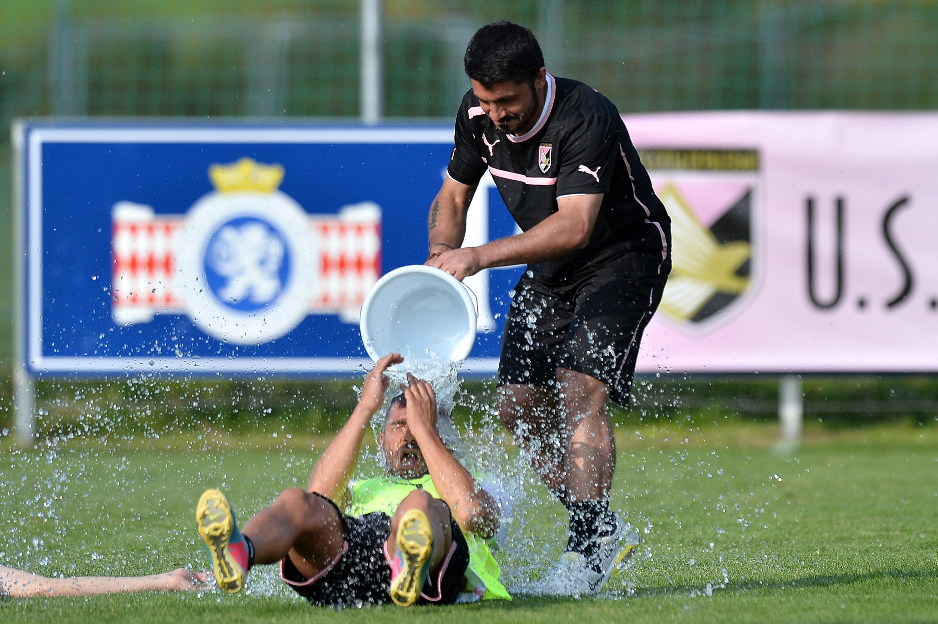 ST VEIT AN DER GLAN, AUSTRIA - JULY 12: Coach Gennaro Gattuso dumps water from a bucket over Gennaro Troianiello after a US Citta di Palermo pre-season training session at Sportzentrum on July 12, 2013 in Sankt Lambrecht near St Veit an der Glan, Austria. (Photo by Tullio M. Puglia/Getty Images)