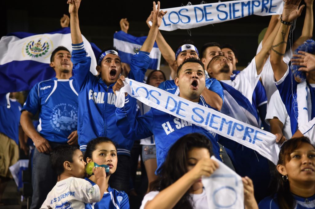 El Salvador fans cheer during the Guatemala vs El Salvador "La Copa Delta" national team soccer friendly on October 13, 2015 at the Stub Hub Center in Carson, California. AFP PHOTO/ ROBYN BECK (Photo credit should read ROBYN BECK/AFP/Getty Images)