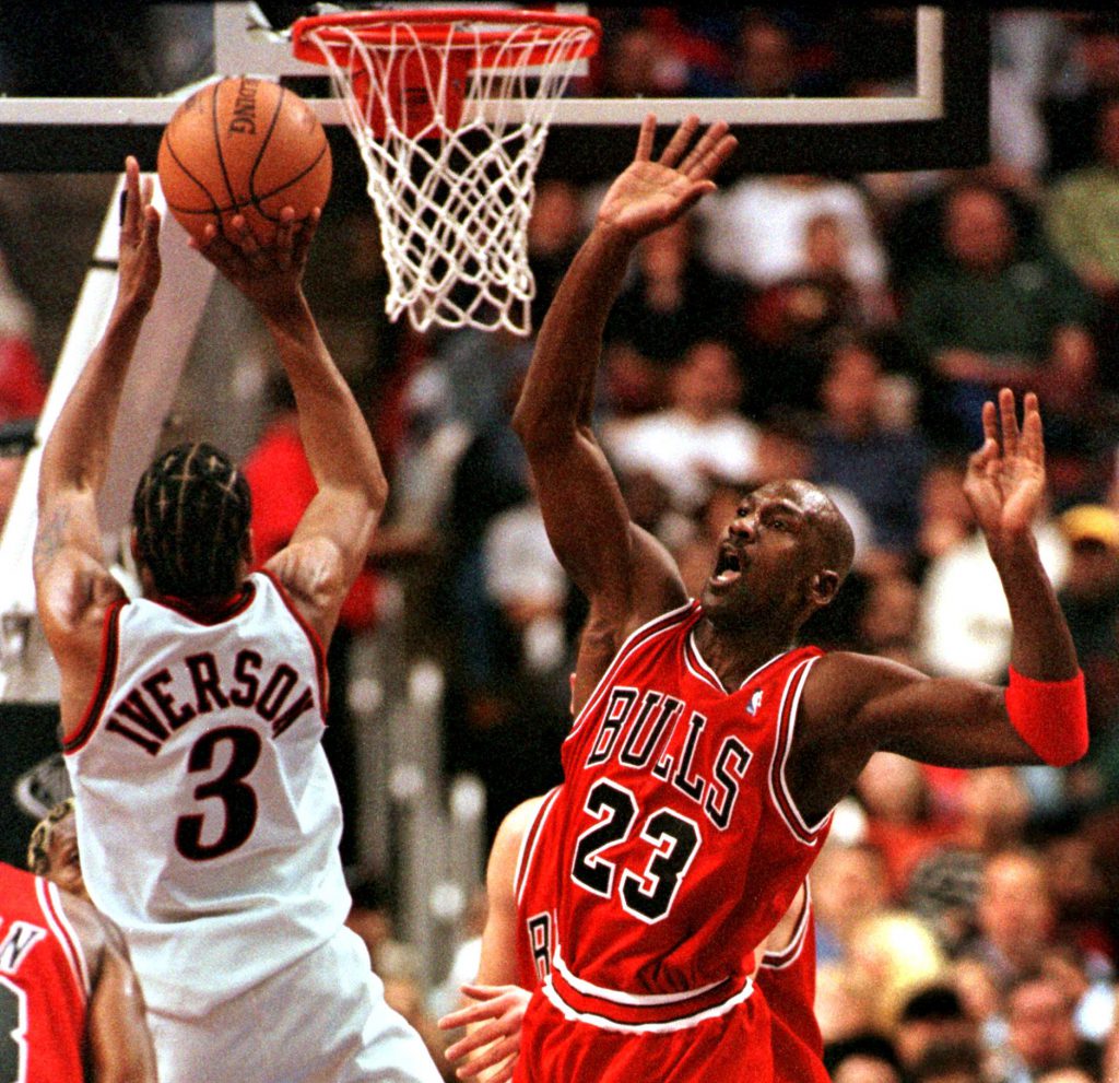 PHILADELPHIA, UNITED STATES: Chicago Bulls Michael Jordan (R) reacts as Philadelphia 76ers Allen Iverson goes up to the basket for two points in the game 15 January in Philadelphia, PA. Iverson's 31 points led the 76ers in their 106-96 upset of the world champion Bulls. AFP PHOTO TOM MIHALEK (Photo credit should read TOM MIHALEK/AFP/Getty Images)