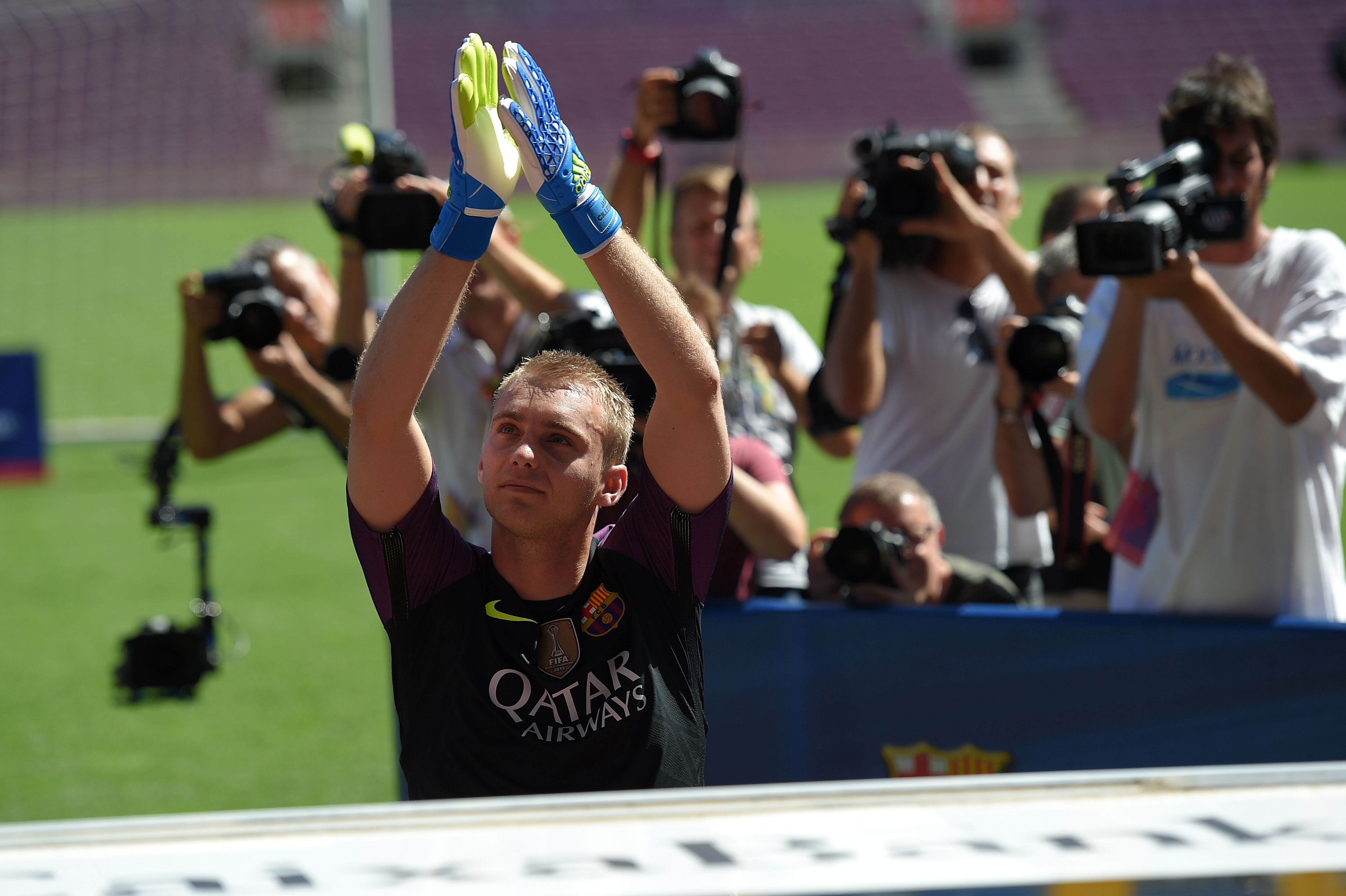 Journalists film FC Barcelona's Dutch goalkeeper Jasper Cillessen applauding on the pitch during his official presentation at the Camp Nou stadium in Barcelona on August 26, 2016, after signing his new contract with the Catalan club. In a statement on their official website the Catalans confirmed they had signed the 27-year-old on a five-year contract for a fee of 13 million euros (£11.1 million, $14.7 million), rising to a potential 15 million euros. / AFP / LLUIS GENE (Photo credit should read LLUIS GENE/AFP/Getty Images)