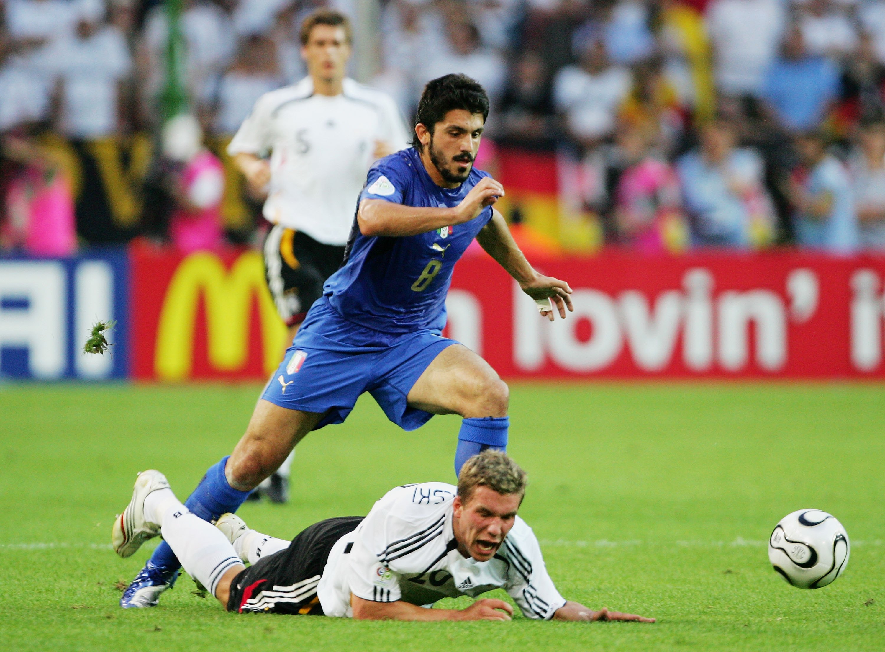 DORTMUND, GERMANY - JULY 04: Lukas Podolski of Germany falls under the challenge of Gennaro Gattuso of Italy during the FIFA World Cup Germany 2006 Semi-final match between Germany and Italy played at the Stadium Dortmund on July 04, 2006 in Dortmund, Germany. (Photo by Alex Livesey/Getty Images)