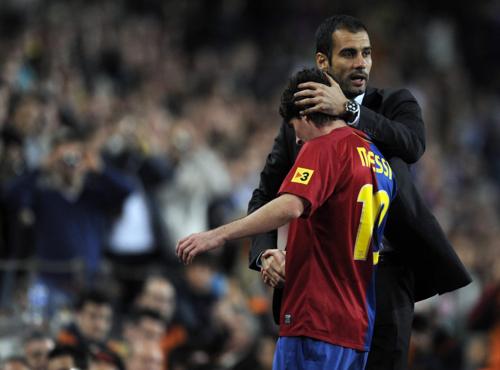 Barcelona's coach Pep Guardiola (L) congratulates his Argentinian attacker Leo Messi after he is substituted during their Spanish League football match against Atletico Madrid at the Camp Nou stadium in Barcelona on October 4, 2008. AFP PHOTO / LLUIS GENE (Photo credit should read LLUIS GENE/AFP/Getty Images)