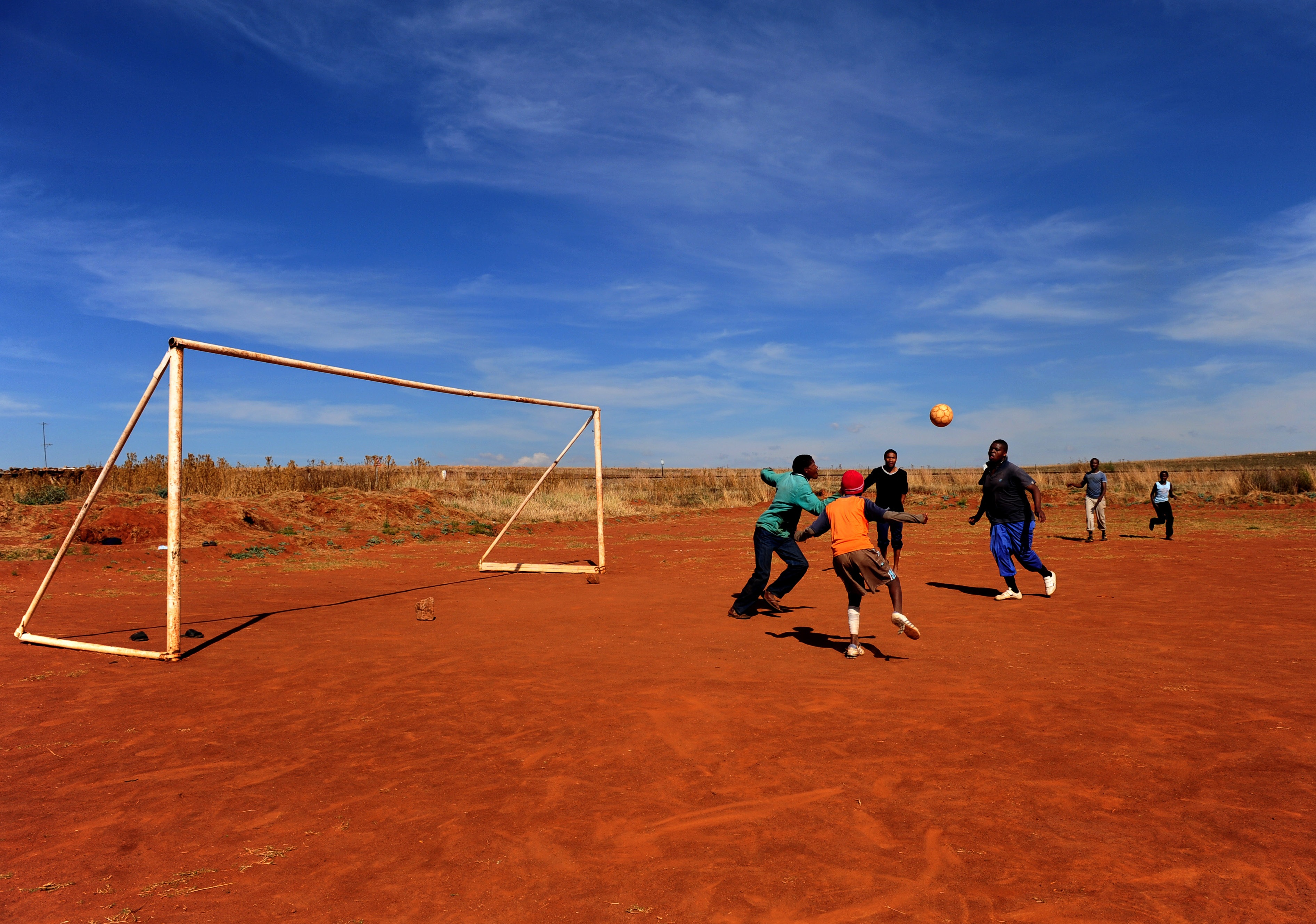 MOGALE CITY, SOUTH AFRICA - JUNE 15: Kids enjoy a game of football on June 15, 2009 in Mogale City, South Africa. Football fever is gripping South Africa as the world's seven regional champions, Italy, Spain, Brazil, Egypt, Iraq, New Zealand, and the United States, compete for the FIFA Confederations Cup. (Photo by Jasper Juinen/Getty Images)