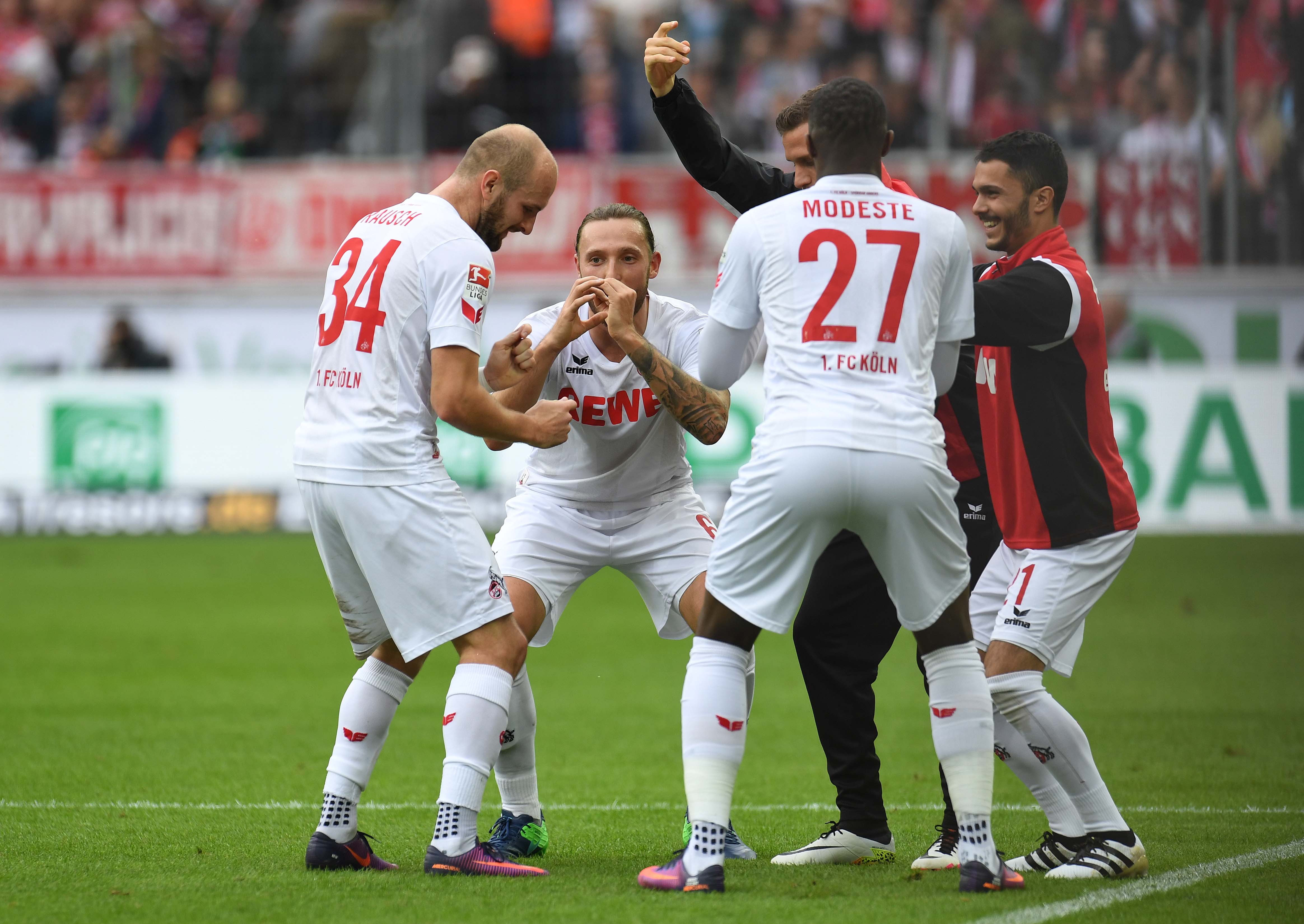 Cologne's French striker Anthony Modeste (27) and teamamtes celebaret after a goal during the German first division Bundesliga football match between FC Cologne and FC Ingolstadt 04, in Cologne, western Germany, on October 15, 2016. / AFP / PATRIK STOLLARZ / RESTRICTIONS: DURING MATCH TIME: DFL RULES TO LIMIT THE ONLINE USAGE TO 15 PICTURES PER MATCH AND FORBID IMAGE SEQUENCES TO SIMULATE VIDEO. == RESTRICTED TO EDITORIAL USE == FOR FURTHER QUERIES PLEASE CONTACT DFL DIRECTLY AT + 49 69 650050 (Photo credit should read PATRIK STOLLARZ/AFP/Getty Images)