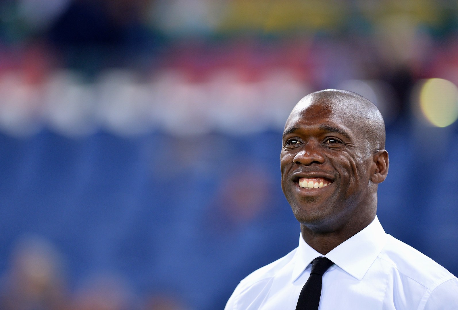 AC Milan's Dutch coach Clarence Seedorf smiles prior the Italian Serie A football match between AS Roma and AC Milan on April 25, 2014 at the Olympic stadium in Rome. AFP PHOTO / ALBERTO PIZZOLI (Photo credit should read ALBERTO PIZZOLI/AFP/Getty Images)