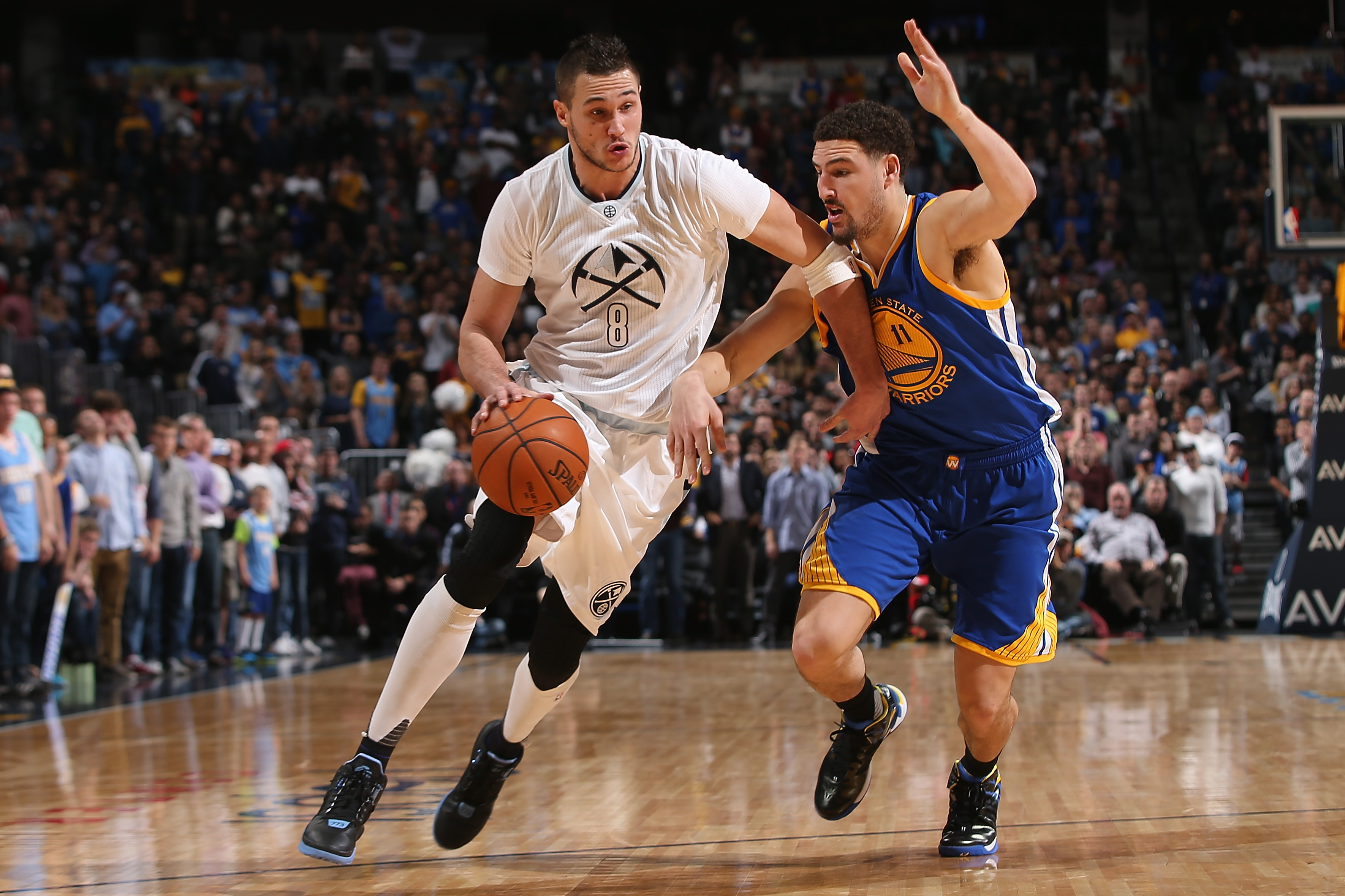 DENVER, CO - JANUARY 13: Danilo Gallinari #8 of the Denver Nuggets controls the ball against Klay Thompson #11 of the Golden State Warriors at Pepsi Center on January 13, 2016 in Denver, Colorado. The Nuggets defeated the Warriors 112-110. NOTE TO USER: User expressly acknowledges and agrees that, by downloading and or using this photograph, User is consenting to the terms and conditions of the Getty Images License Agreement. (Photo by Doug Pensinger/Getty Images)