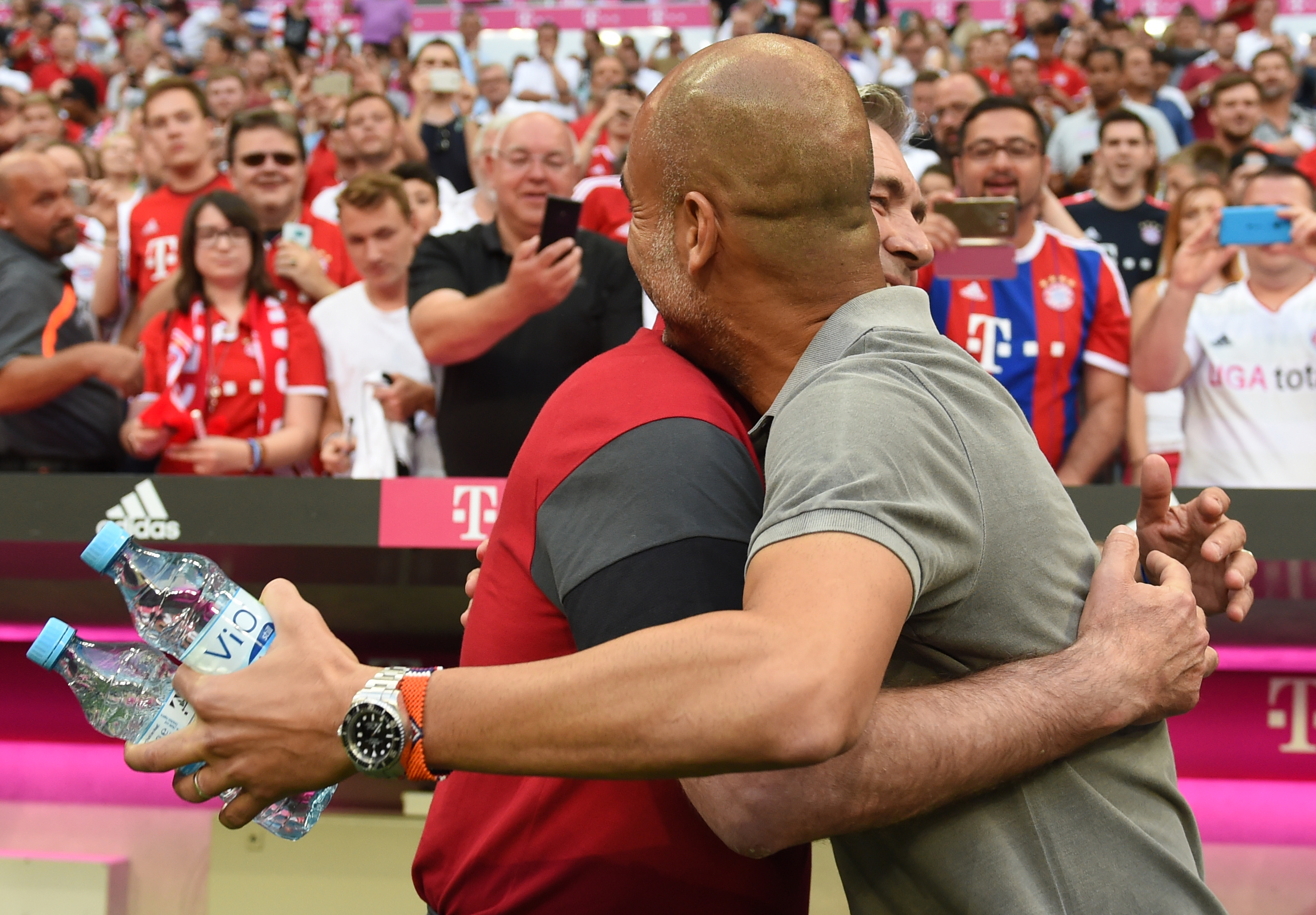 Bayern Munich's Italian headcoach Carlo Ancelotti (L) embraces Manchester's Spanish headcoach Pep Guardiola prior to a friendly soccer match between the German first division Bundesliga club FC Bayern Munich and the Premier League football team Manchester City in Munich, southern Germany, on July 20, 2016. / AFP / CHRISTOF STACHE (Photo credit should read CHRISTOF STACHE/AFP/Getty Images)