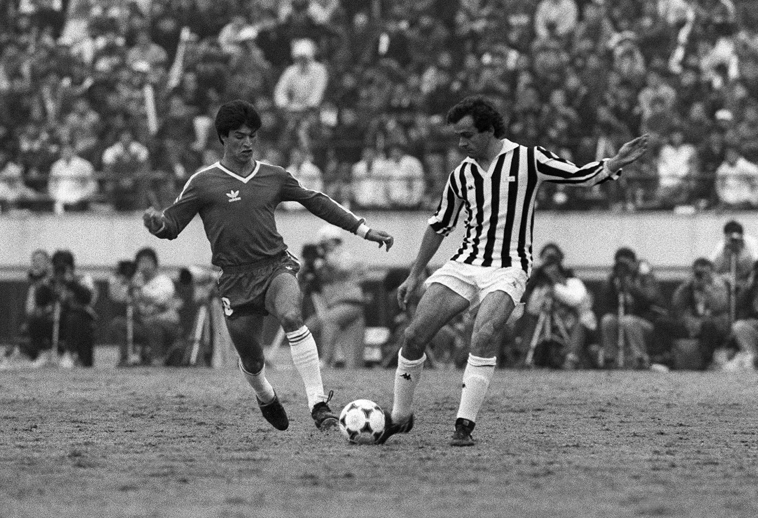 Michel Platini (R) of Juventus is fighting for the ball against Claudio Borghi (L) of Argentinos Juniors during the 6th Toyoto European/South American Cup held in Tokyo 08 December 1985. The Juventus from Italy got the title 4-3 in a match decided by penalty shots after fulltime and extra-time left the both teams tied 2-2.(FILM) AFP PHOTO (Photo credit should read /AFP/Getty Images)