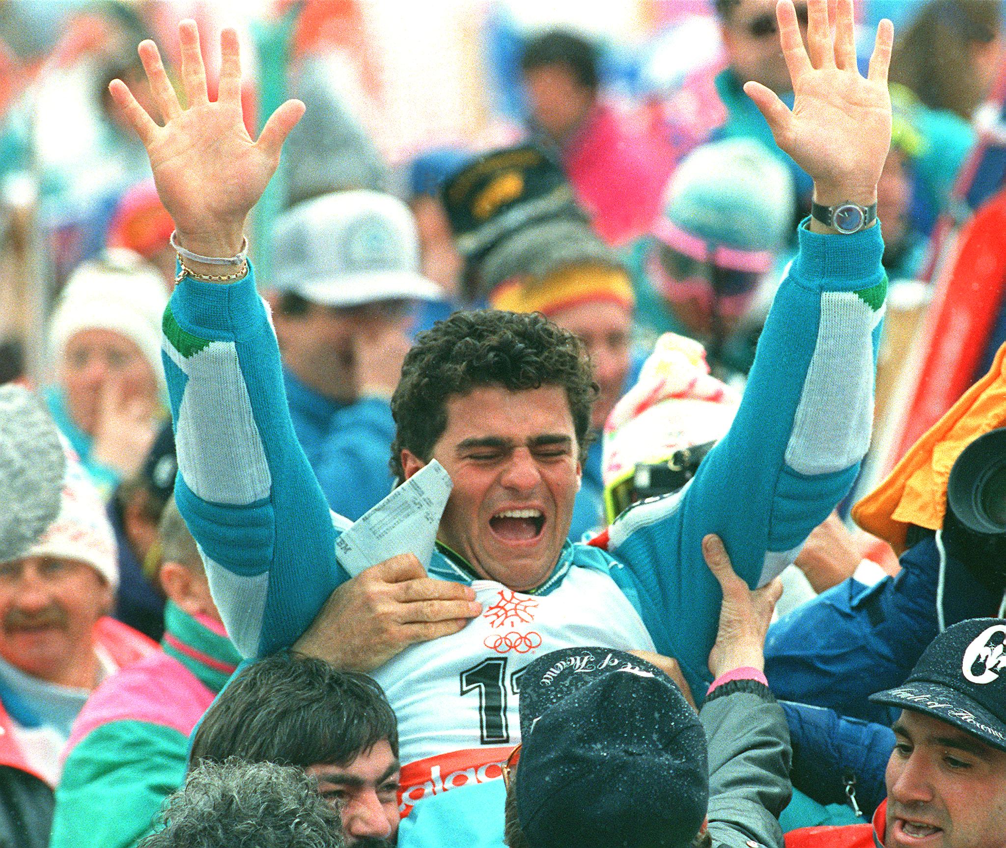 Italian skier Alberto Tomba, surrounded by fans, reacts after his victory in the men's slalom 27 February 1988 in Nakiska at the Winter Olympic Games. Tomba won the gold medal. AFP PHOTO/ROBERTSON (Photo credit should read ROBERTSON/AFP/Getty Images)