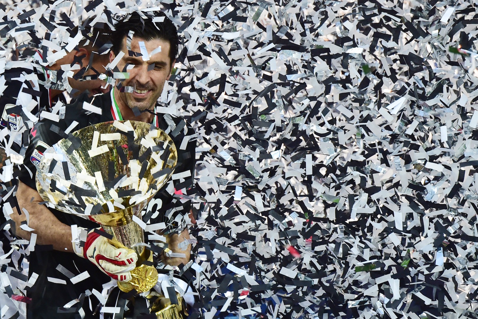 Juventus' goalkeeper and captain Gianluigi Buffon celebrates with the Italian League's trophy during a ceremony following the Italian Serie A football match Juventus vs Napoli on May 23, 2015 at the Juventus stadium in Turin. Juventus won the Coppa Italia on May 20, 2015 and the Italian League today after their 3-1 victory over Napoli. AFP PHOTO / GIUSEPPE CACACE (Photo credit should read GIUSEPPE CACACE/AFP/Getty Images)