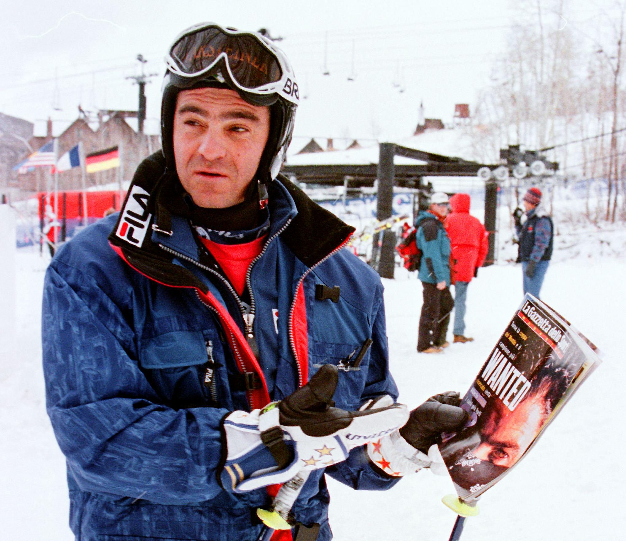 Italian World Cup skier Alberto Tomba holds an Ita