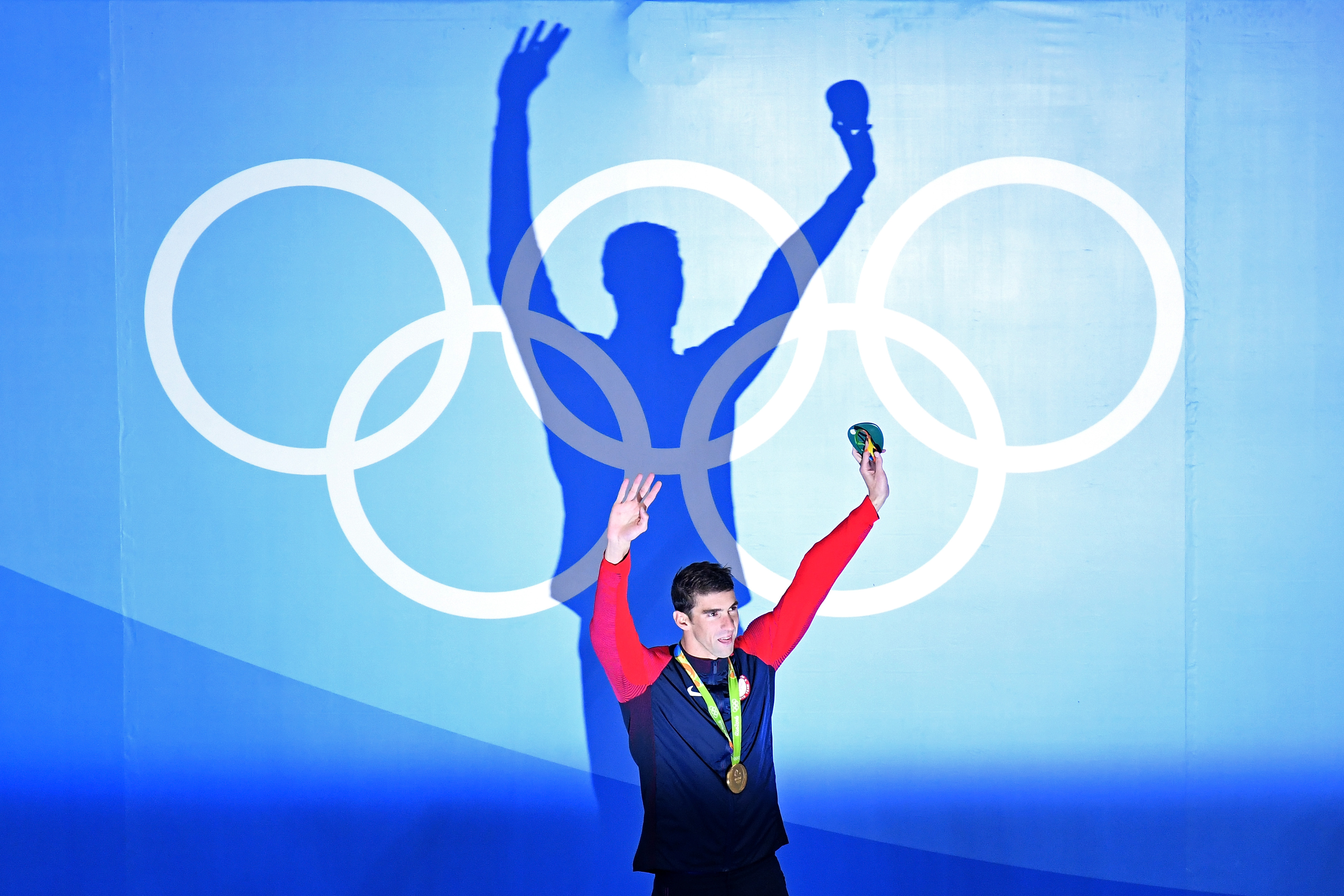 RIO DE JANEIRO, BRAZIL - AUGUST 09: Gold medalist Michael Phelps of the United States celebrates on the podium during the medal ceremony for the Men's 200m Butterfly Final on Day 4 of the Rio 2016 Olympic Games at the Olympic Aquatics Stadium on August 9, 2016 in Rio de Janeiro, Brazil. (Photo by Richard Heathcote/Getty Images)