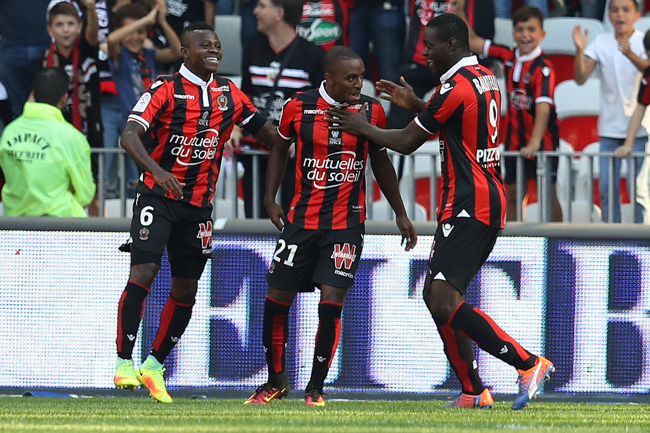 Nice's Portuguese defender Ricardo Pereira (C) celebrates after scoring a goal with team mates Ivorian midfielder Jean Michael Seri (L) and Italian forward Mario Balotelli (R) during a French L1 football match between Nice (OGCN) and Lorient (FCL) on October 2, 2016 at the "Allianz Riviera" stadium in Nice, southeastern France. / AFP / VALERY HACHE (Photo credit should read VALERY HACHE/AFP/Getty Images)