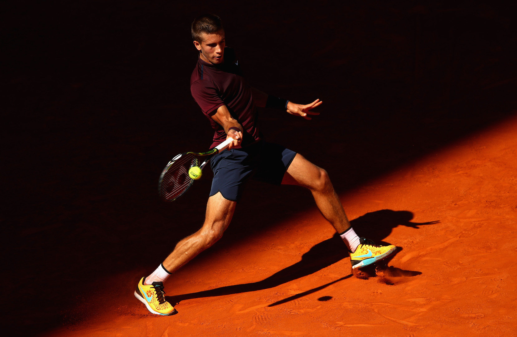 MADRID, SPAIN - MAY 04: Borna Coric of Croatia plays a forehand against Novak Djokovic of Serbia in their second round match during day five of the Mutua Madrid Open tennis tournament at the Caja Magica on May 04, 2016 in Madrid. (Photo by Clive Brunskill/Getty Images)