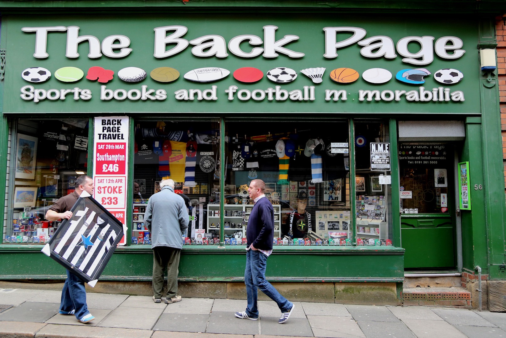 NEWCASTLE, UNITED KINGDOM - MARCH 22: Newcastle fans and staff members at the Back Page sports memorabilia shop chat before the Barclays Premier League match between Newcastle United and Crystal Palace at St James' Park on March 22, 2014 in Newcastle upon Tyne, England. (Photo by Ian Horrocks/Getty Images)