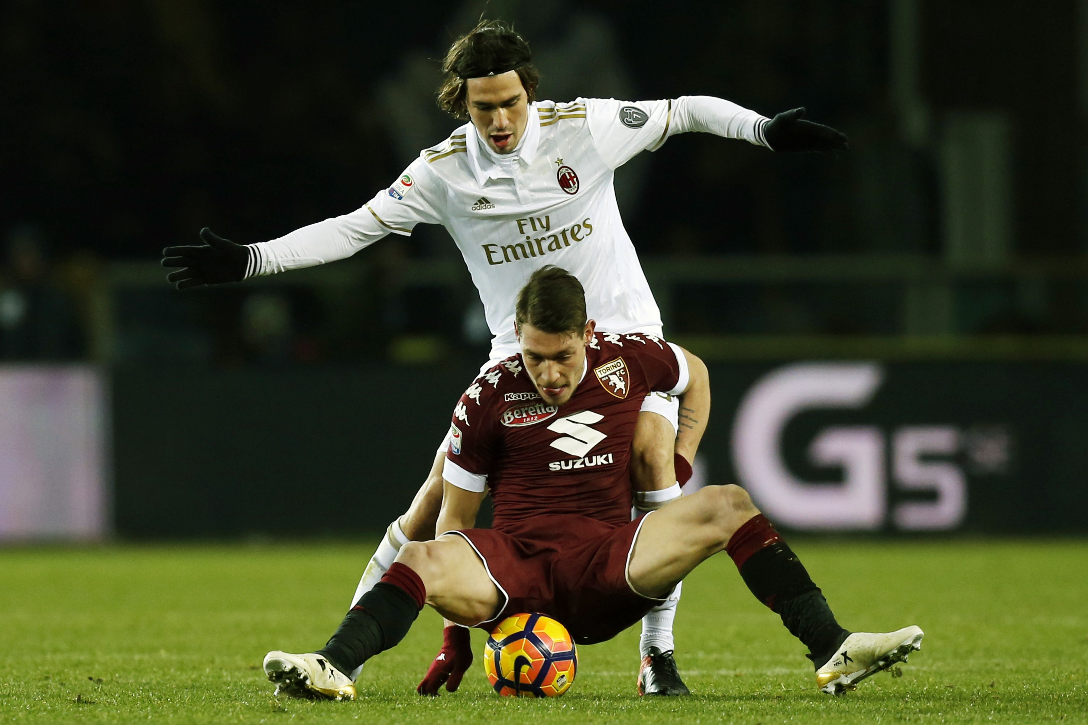 AC Milan's defender Alessio Romagnoli (top) vies with Torino's forward Andrea Belotti during the Italian Serie A football match Torino Vs AC Milan on January 16, 2017 at the 'Grande Torino Stadium' in Turin. / AFP / MARCO BERTORELLO (Photo credit should read MARCO BERTORELLO/AFP/Getty Images)